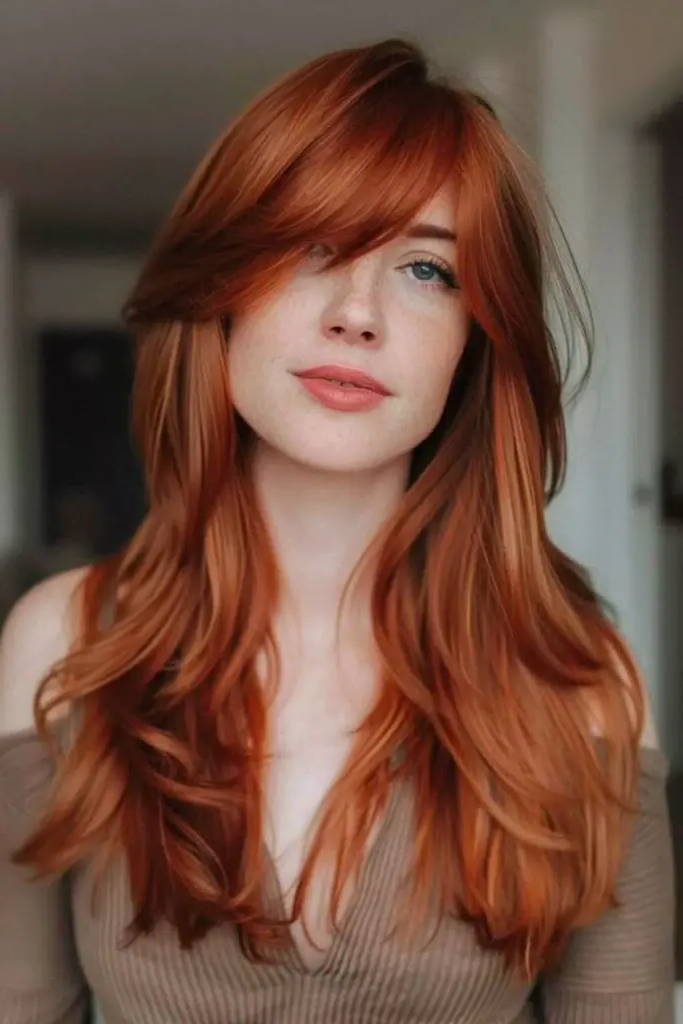 27 Long Layered Haircuts with Face Framing 12 10. Ember Glow Locks
