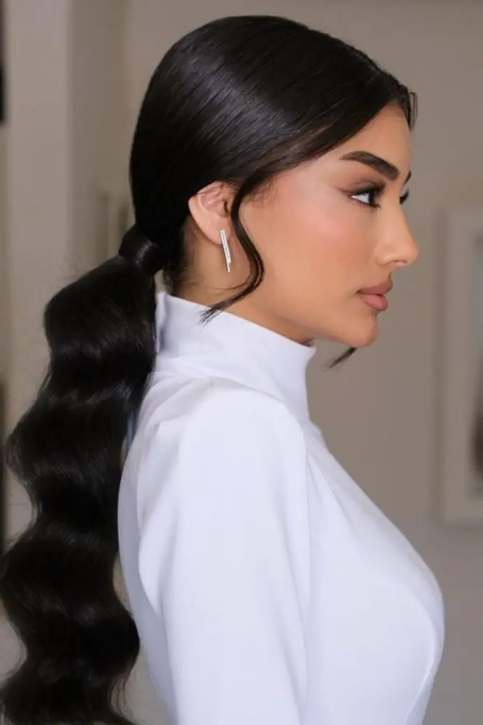 27 Easy Latina Hairstyles 13 11. Low Ponytail with Twist and Pin
