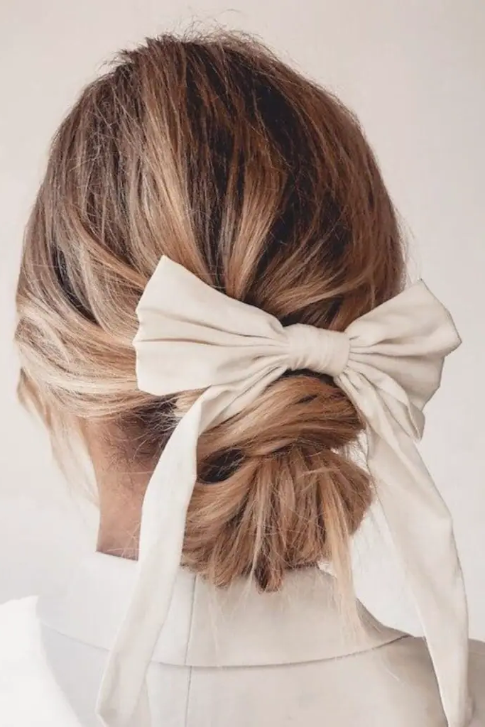 28 Cute Hairstyles with a Bow 15 13. Bow-Bedecked Messy French Twist
