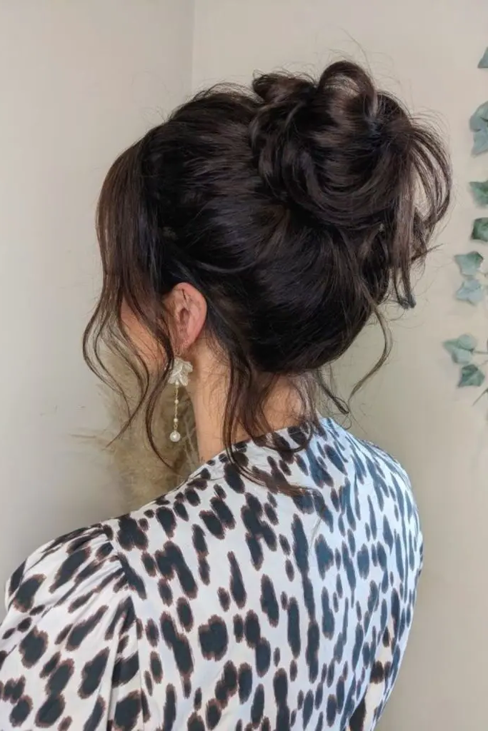 27 Easy Latina Hairstyles 15 13. High Bun with Loose Strands