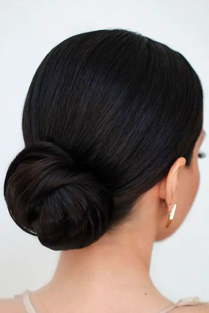 29 Cute Latina Hairstyles Long 17 15. Sleek Low Bun with a Twist