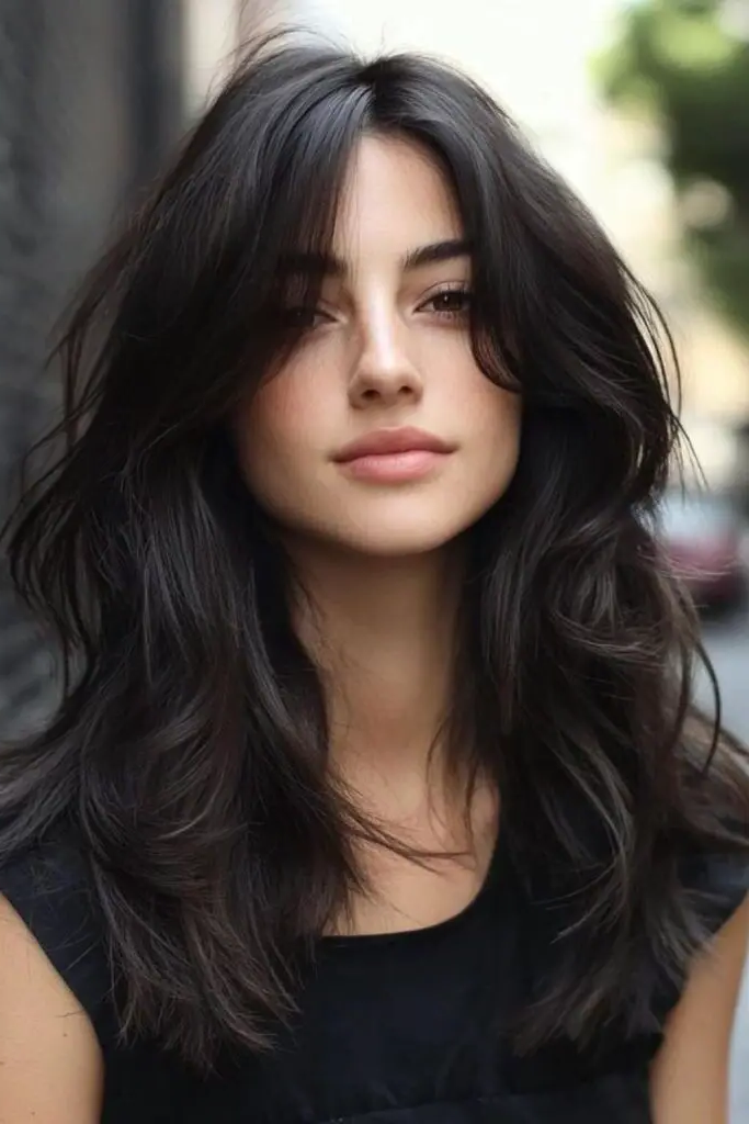 29 Wavy Layered Haircuts 17 16. Raven Cascade Layers