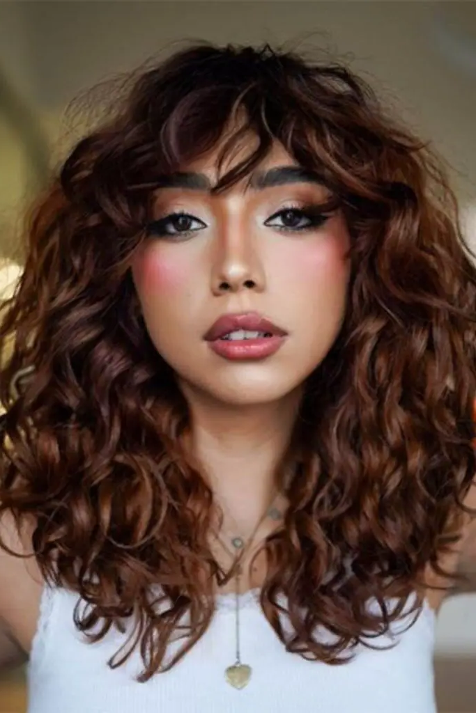 29 Stunning Butterfly Bangs Hairstyles 24 22. Curly Butterfly Bangs: Fun and Flirty