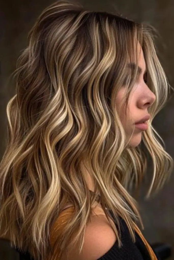 24. Soft Golden Blonde Highlights on Dark Hair