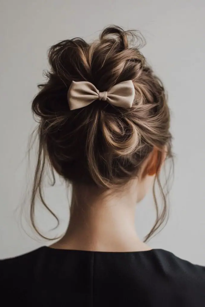 28 Cute Hairstyles with a Bow 6 4. Messy Bun with Bow Accent