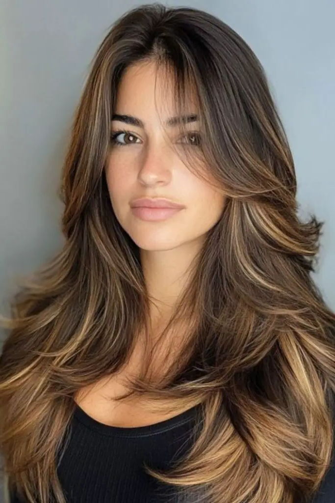 29 Long Layers with Curtain Bangs 6 4. Sunlit Cascade Elegance