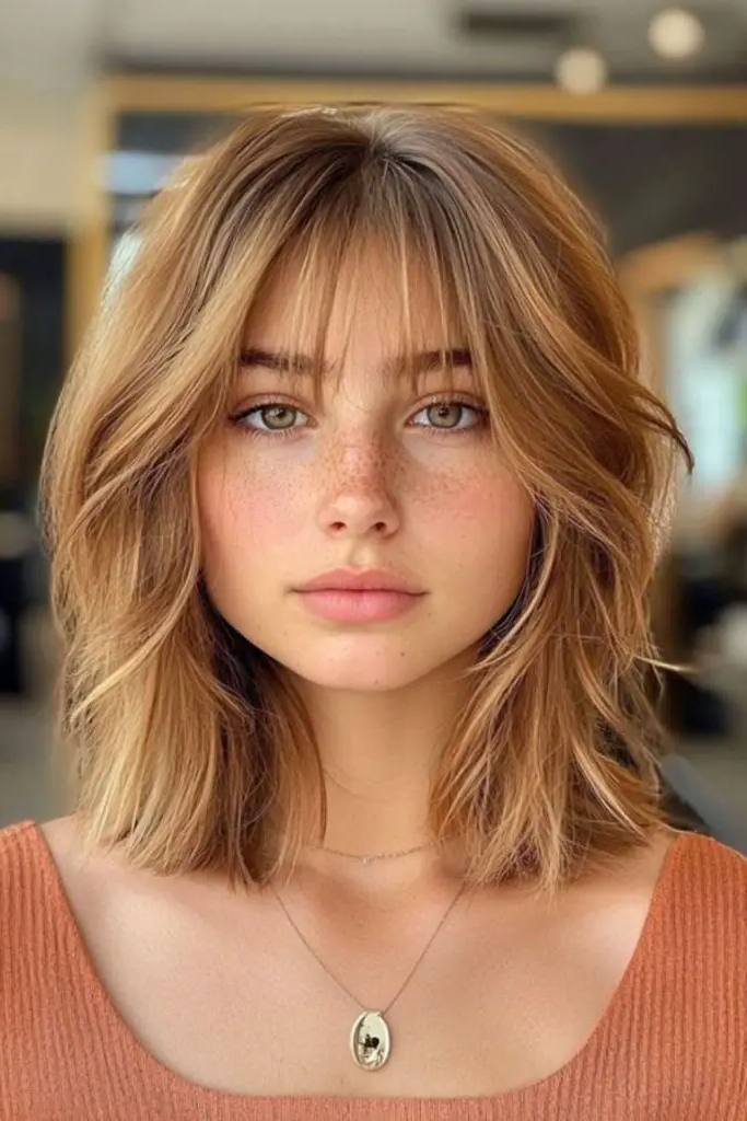27 Best Lob Haircut with Bangs 10 8. Layered Sunset Glow