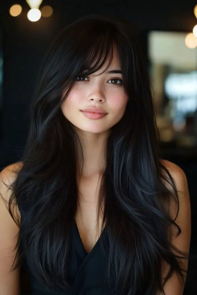 29 Long Layers with Curtain Bangs 10 8. Midnight Silk Strokes