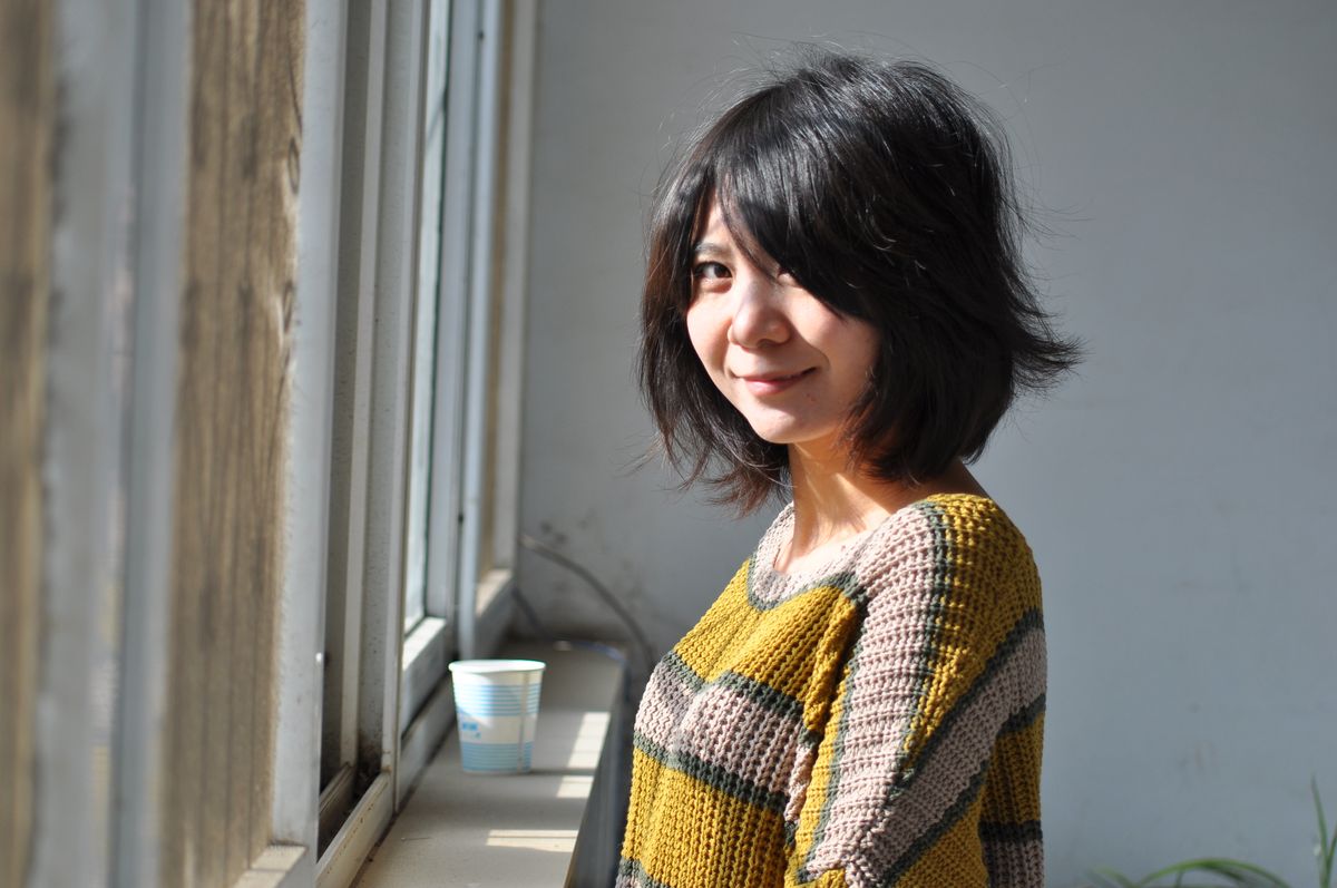 The Blunt Bob Haircut: A Timeless and Sleek Style for Women 2 Woman with a softly styled bob hairstyle by a window