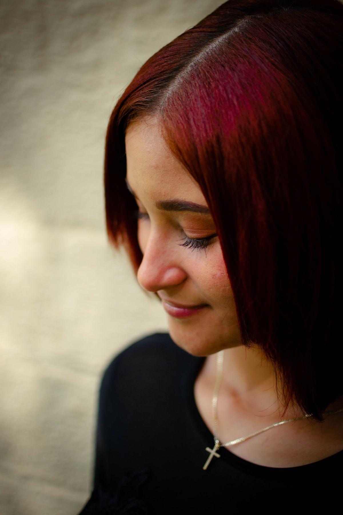 Woman with red-dyed cherry cola hair color