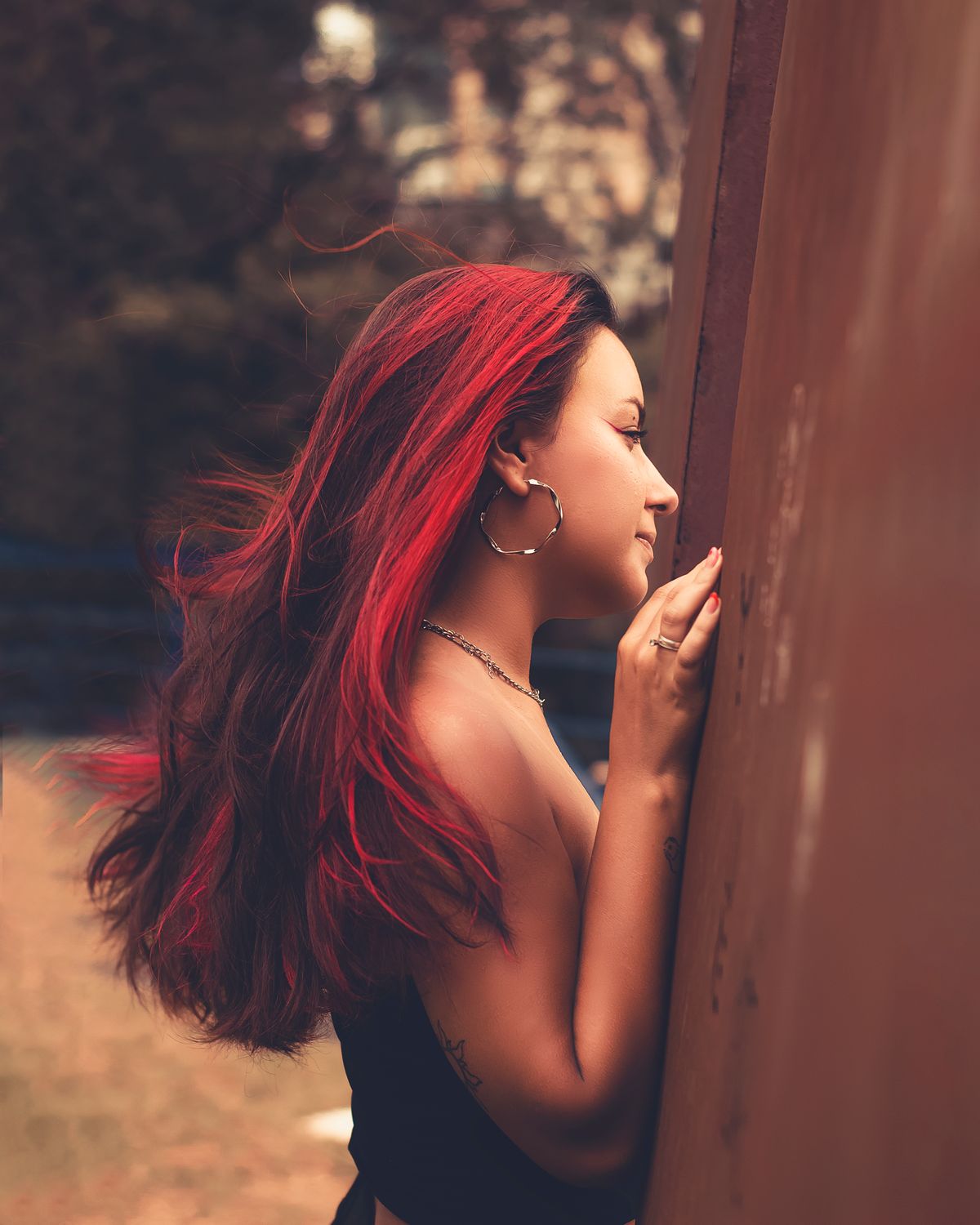 The Bold Beauty of Cherry Cola Hair Color for Women 2 Woman with vibrant cherry cola red hair outdoors