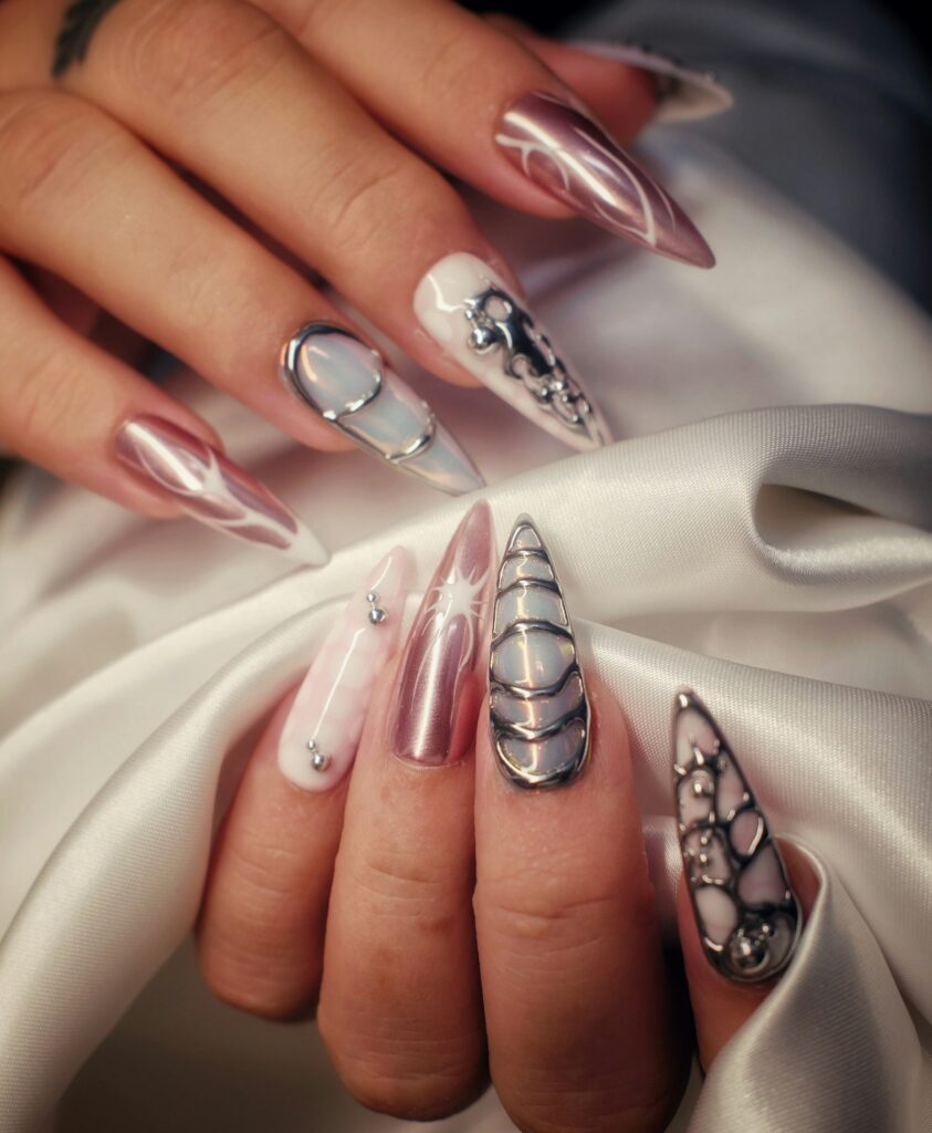 Woman's hands with metallic chrome and jeweled stiletto nail art