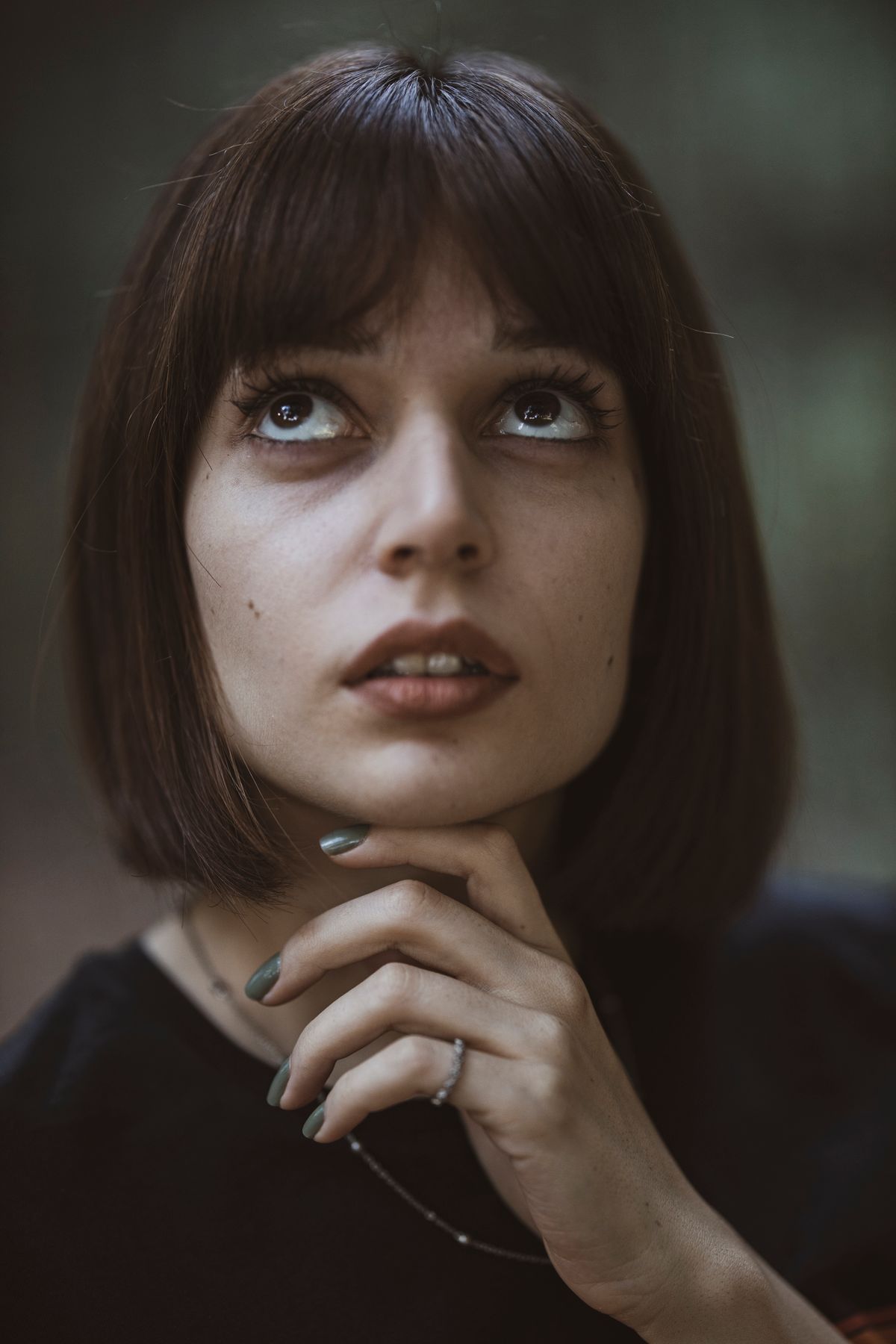 Woman with soft face-framing curtain bangs
