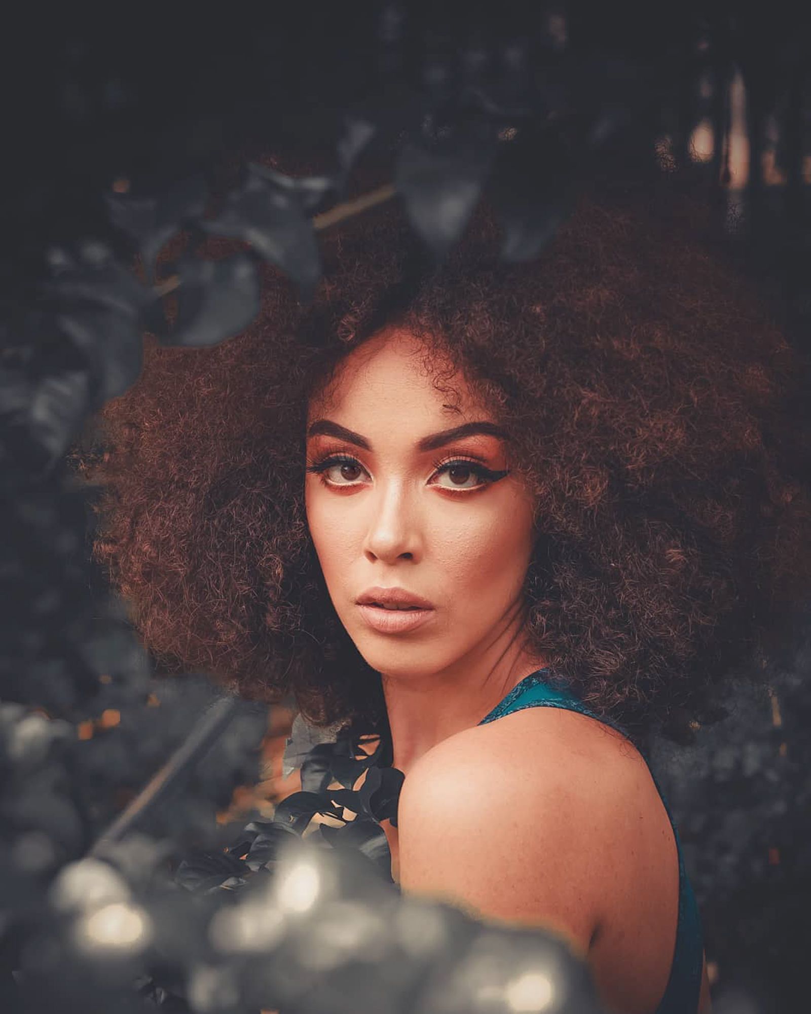 Curly Haircuts: Embracing Natural Beauty with Style and Versatility 8 Woman with defined natural curls from a curl-by-curl cut