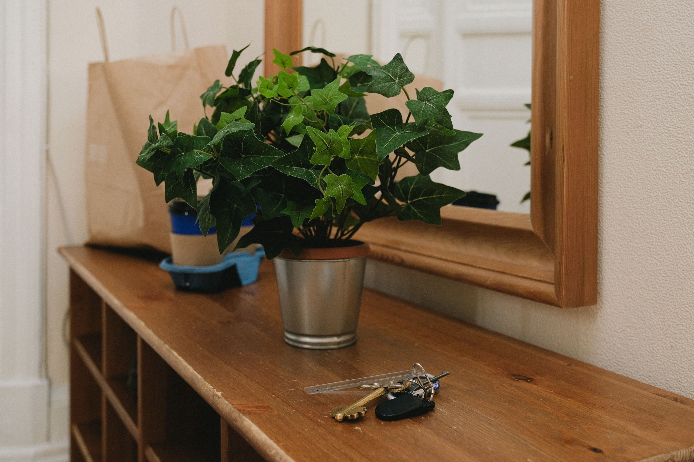 Entryway Decor Ideas That Make a Small Space Feel Welcoming 2 Entryway console table with keys and a potted plant