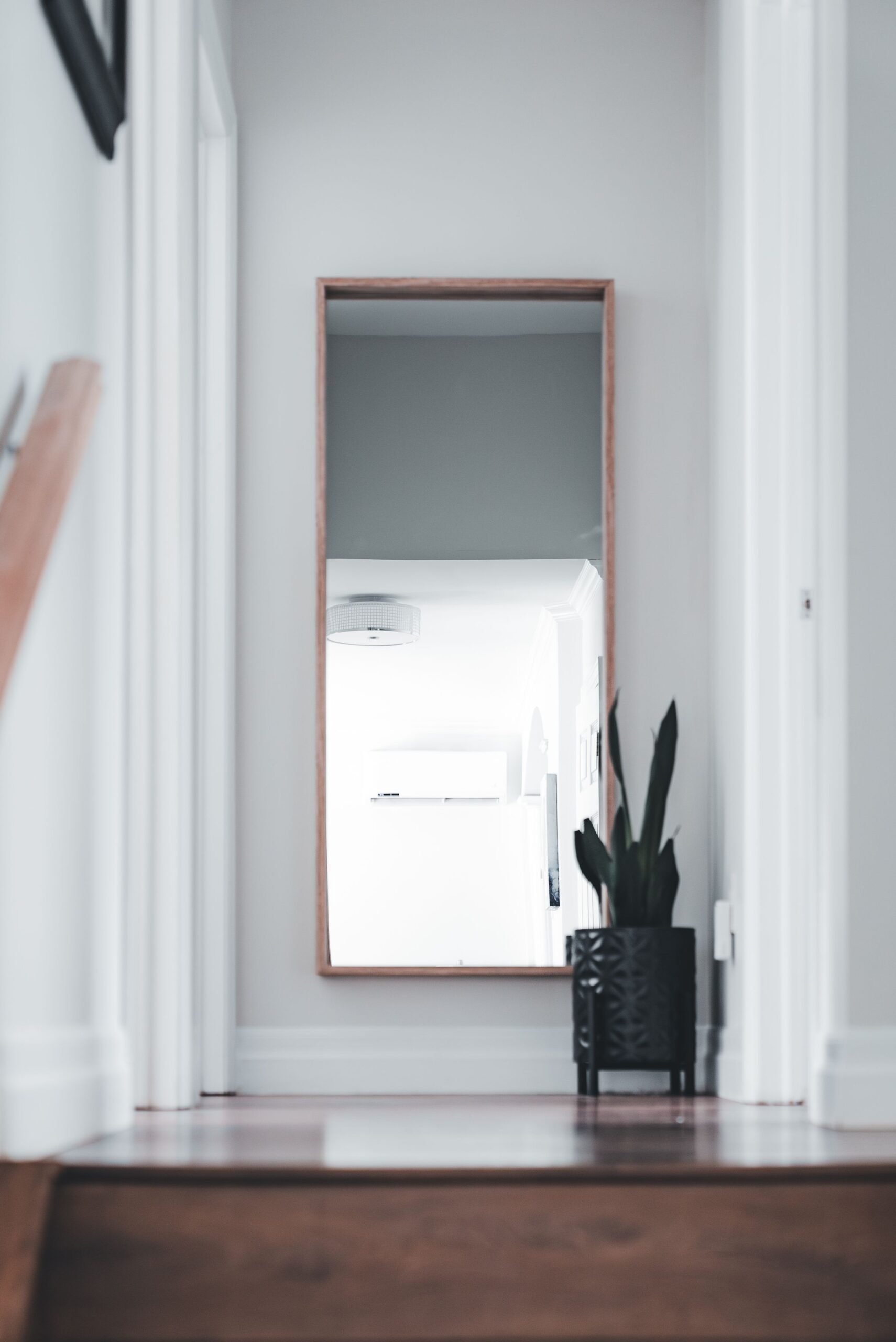 Entryway Decor Ideas That Make a Small Space Feel Welcoming 3 Full-length mirror leaning against a bright hallway wall