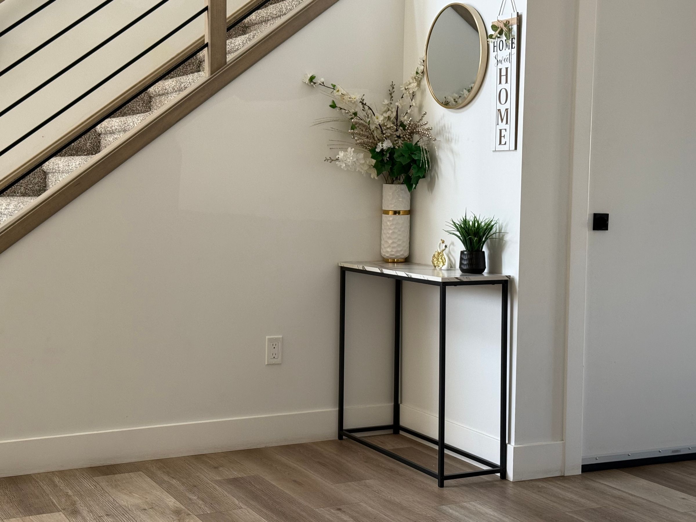 Entryway Decor Ideas That Make a Small Space Feel Welcoming 8 Neutral-toned entryway console table with mirror and greenery