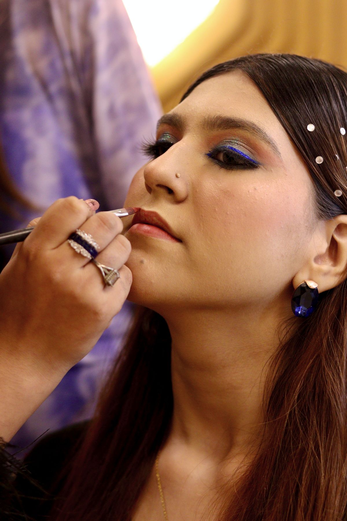 The Art of Make-Up: Enhancing Beauty with Creativity and Confidence 2 Woman getting professional eye and lip makeup applied