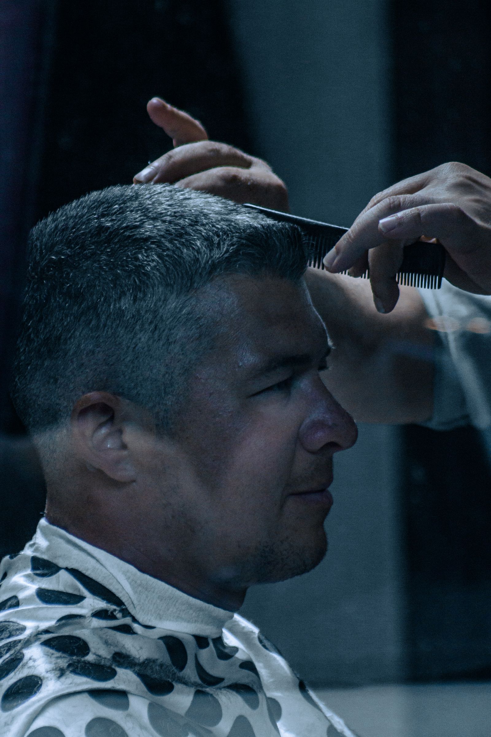 The Fade Haircut: A Modern Classic for Men 5 Barber giving a client a fade haircut