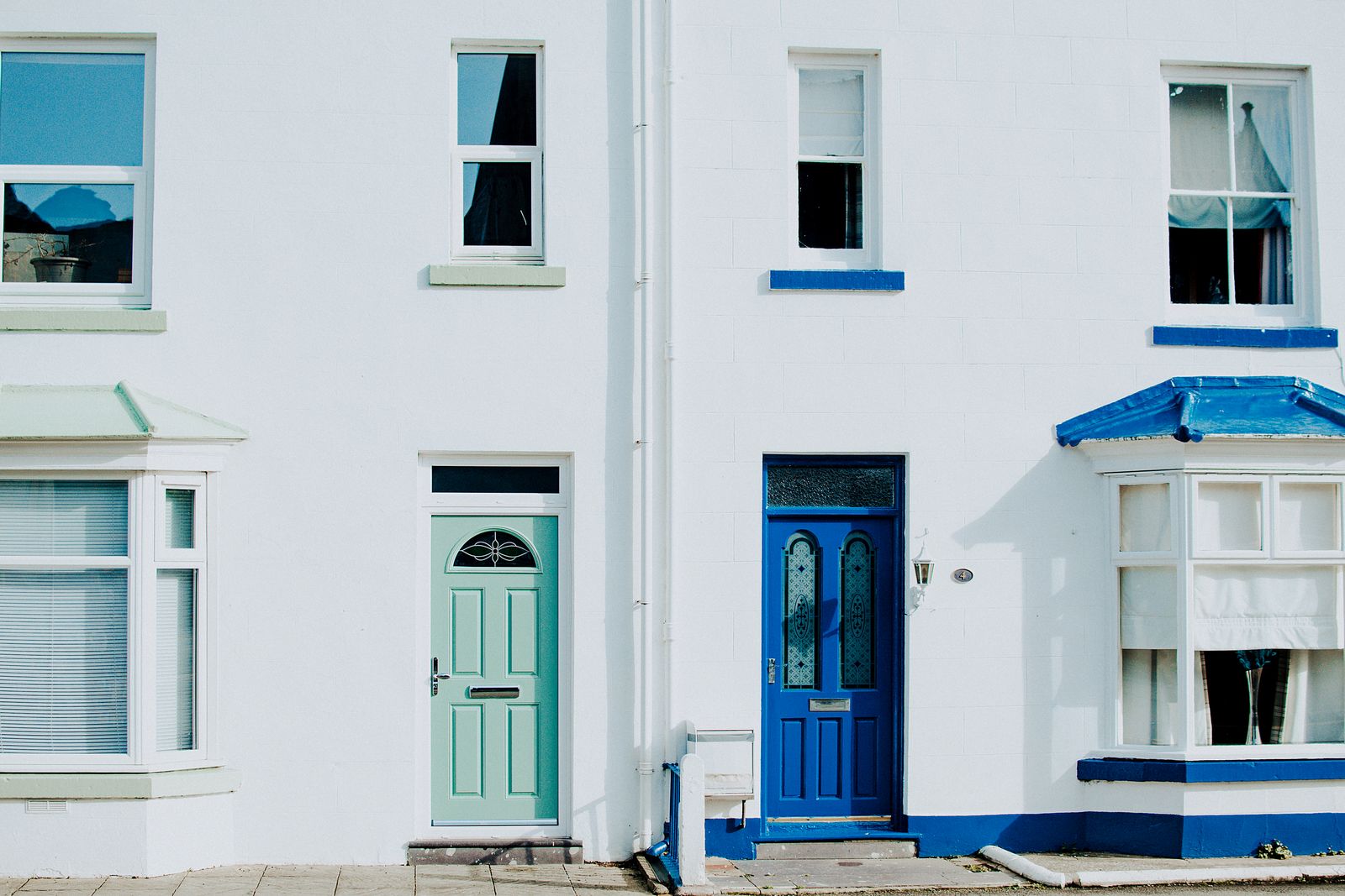 Colorful painted front doors on a house exterior