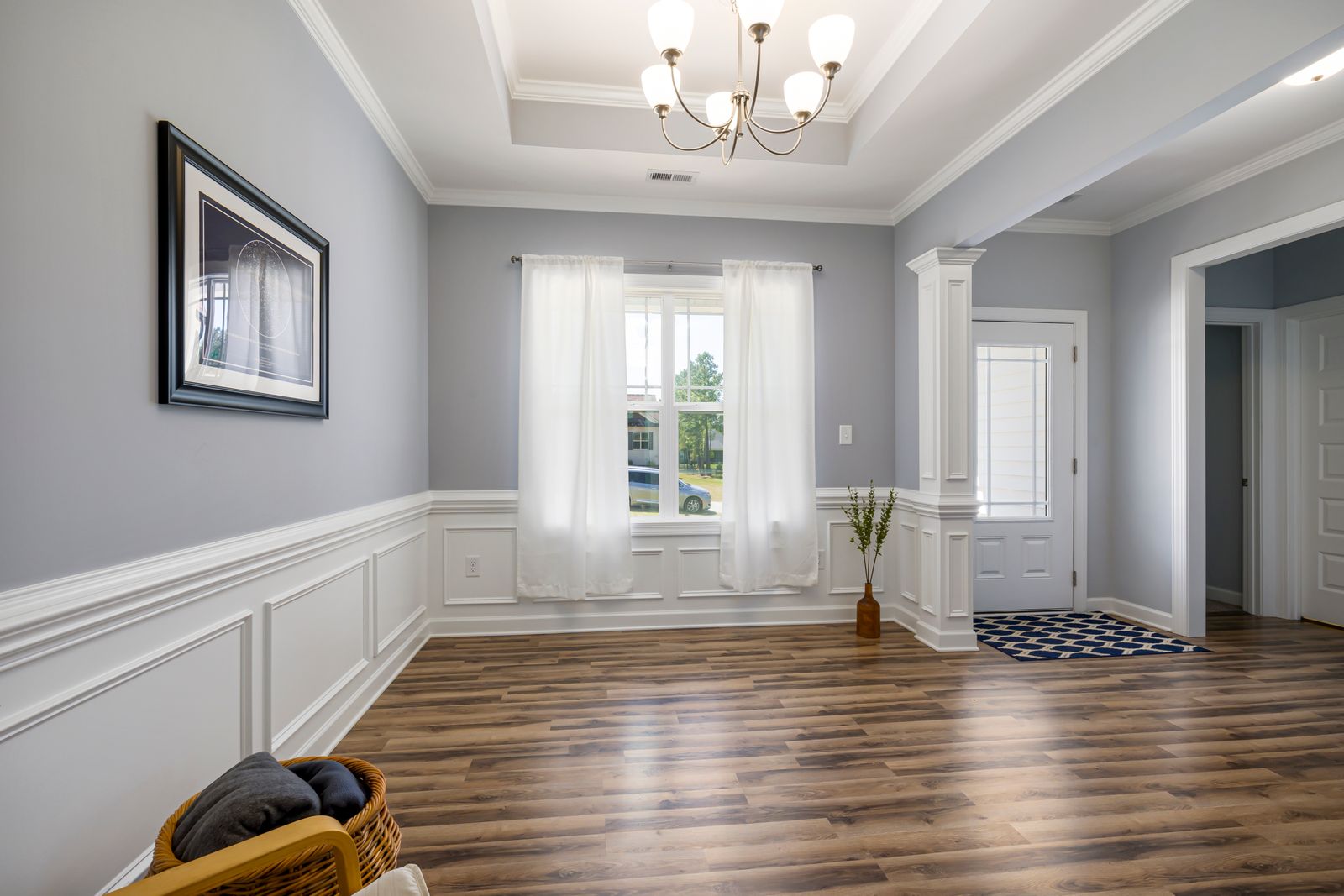 Living room with crown molding and wainscoting trim