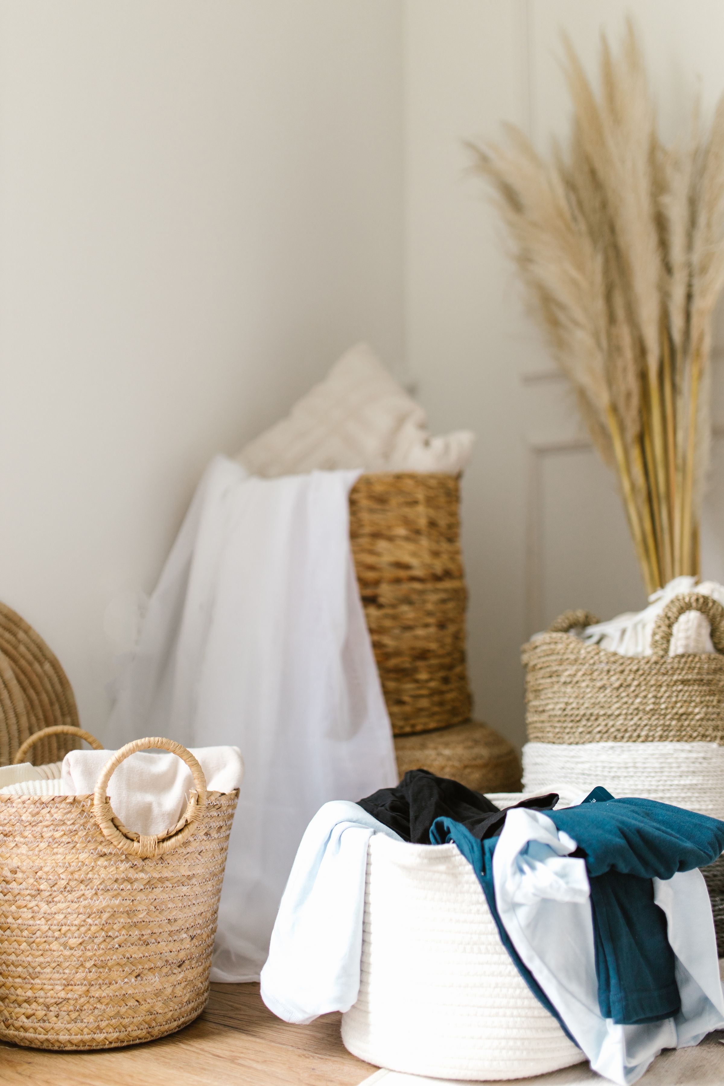 Laundry Room Organization Ideas That Actually Make Sense 6 Woven storage baskets grouped together with folded laundry