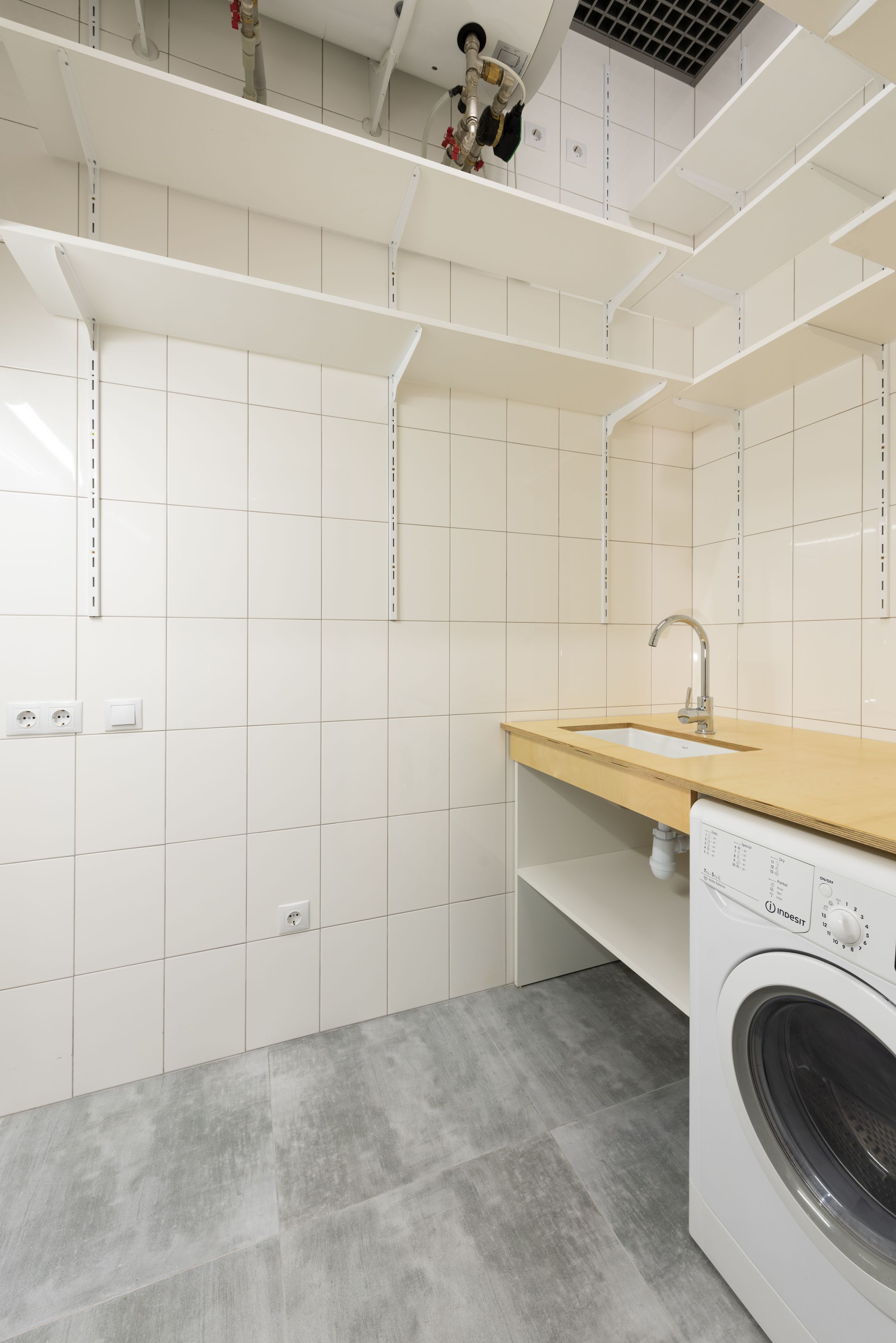 Laundry Room Organization Ideas That Actually Make Sense 7 White tiled utility room with wood counter and sink above washer