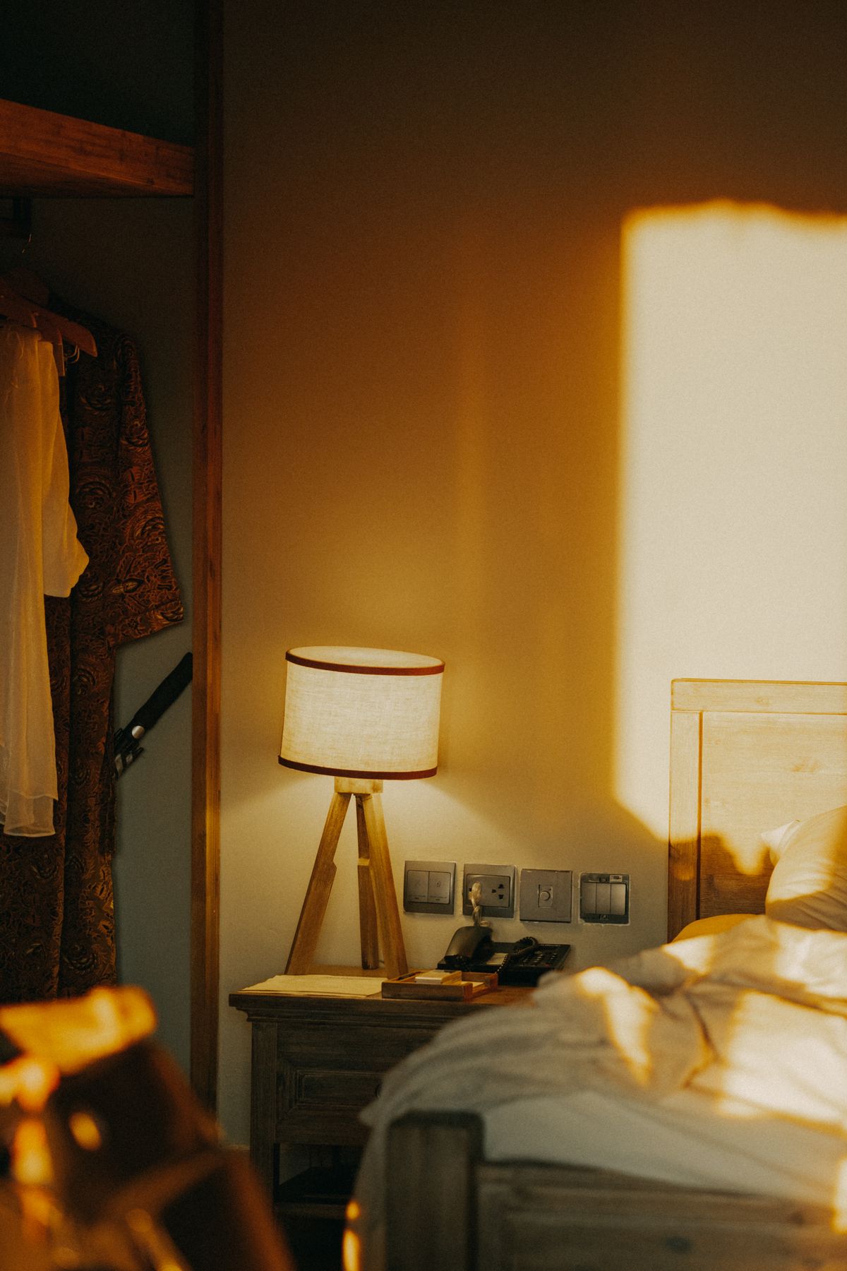 Sunlit room with warm tones and a stylish bedside lamp