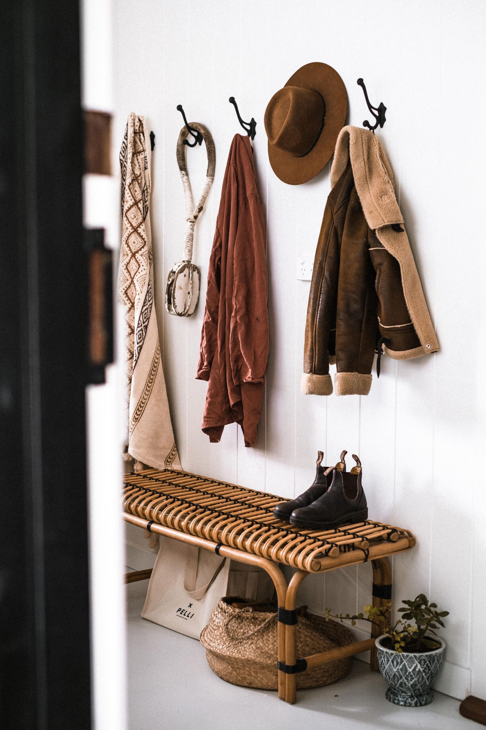 7 Mudroom Organization Ideas That Actually Make Sense 3 Coat hanging on a wall hook in an entryway