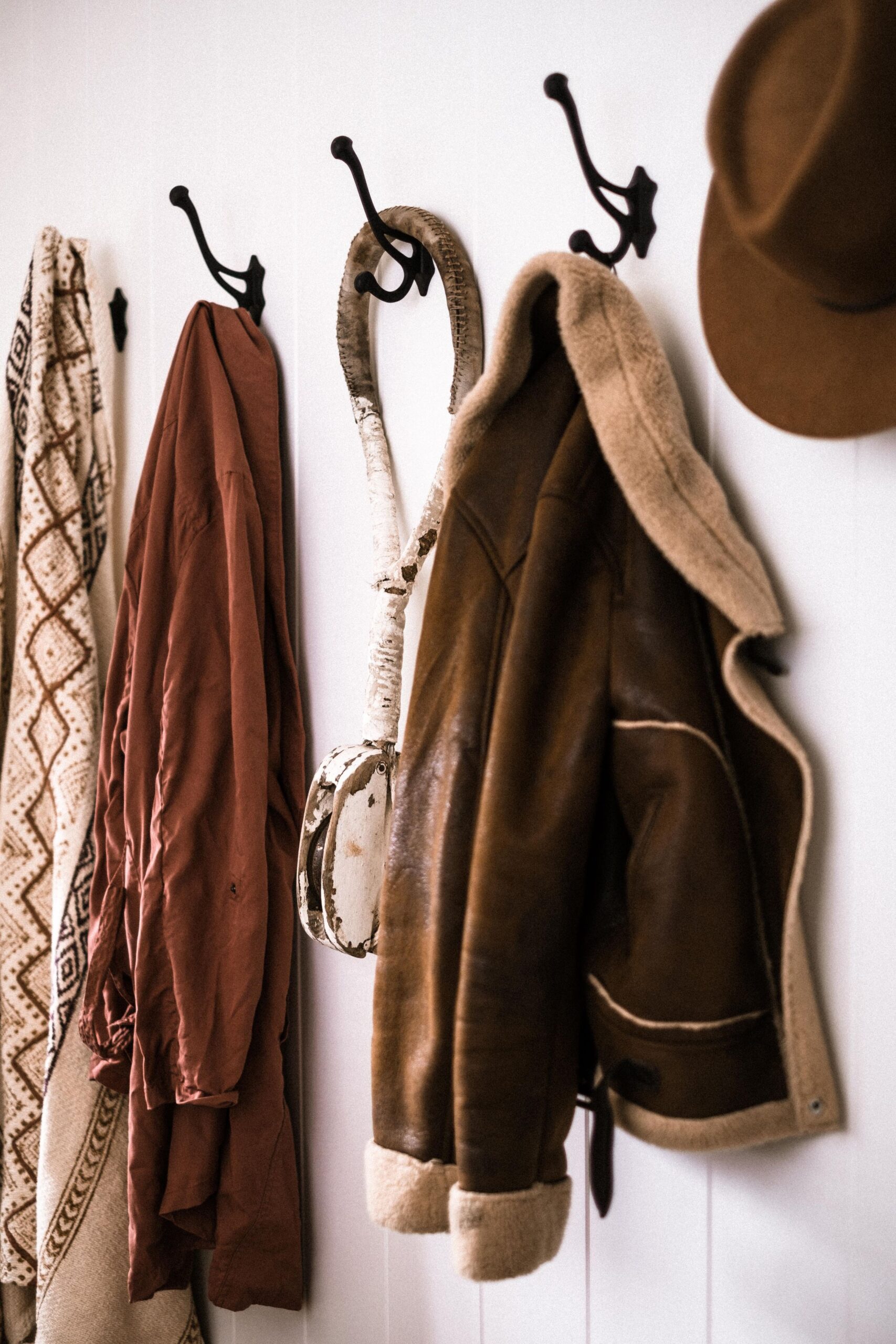 7 Mudroom Organization Ideas That Actually Make Sense 4 Row of clothes hanging on wall hooks