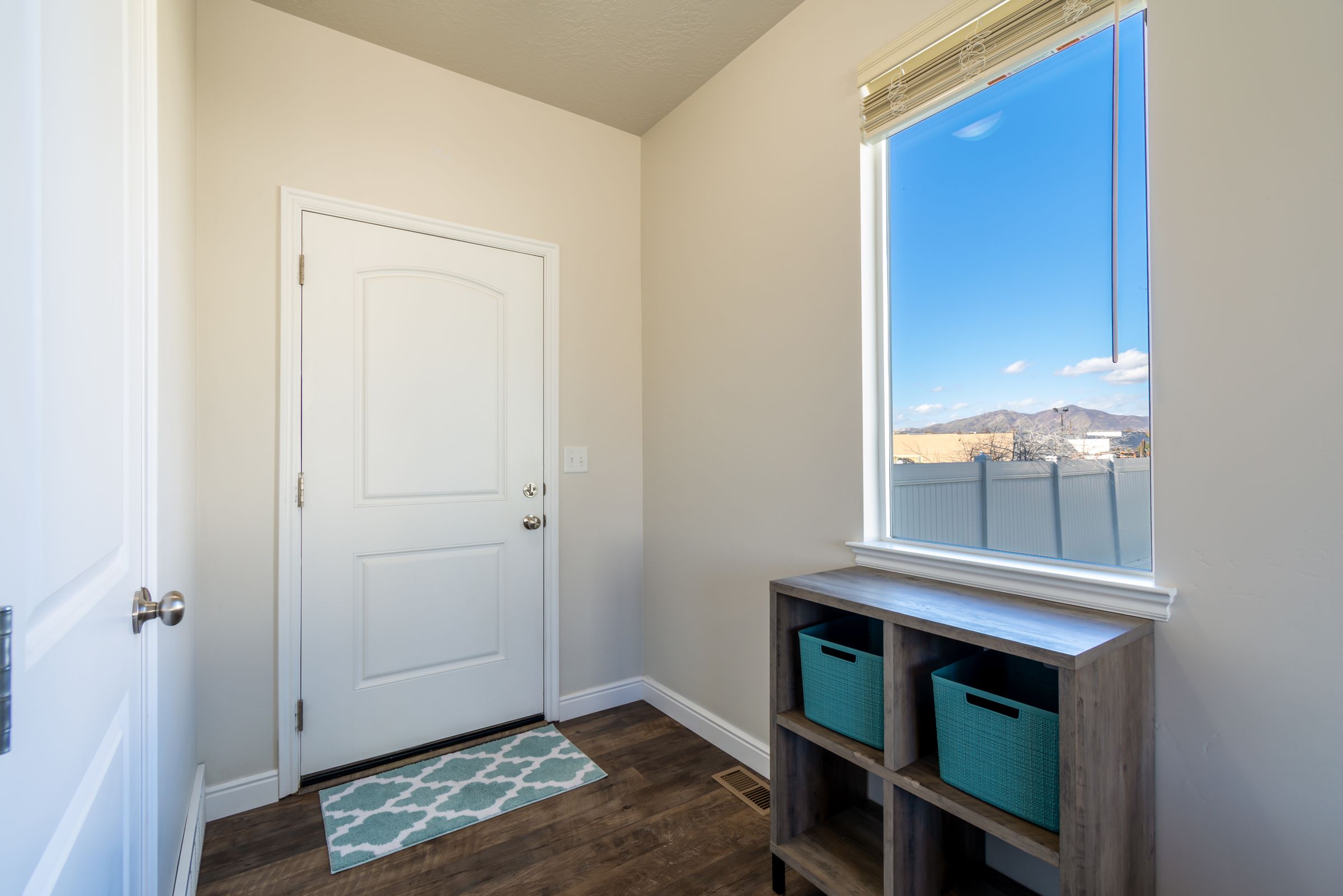 7 Mudroom Organization Ideas That Actually Make Sense 8 Floating shelf installed under a window in an entryway