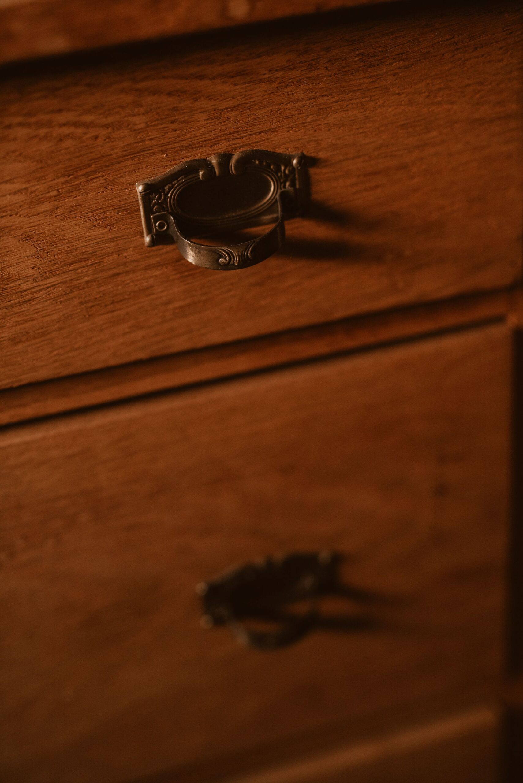 Brass drawer pulls and hardware on wooden furniture
