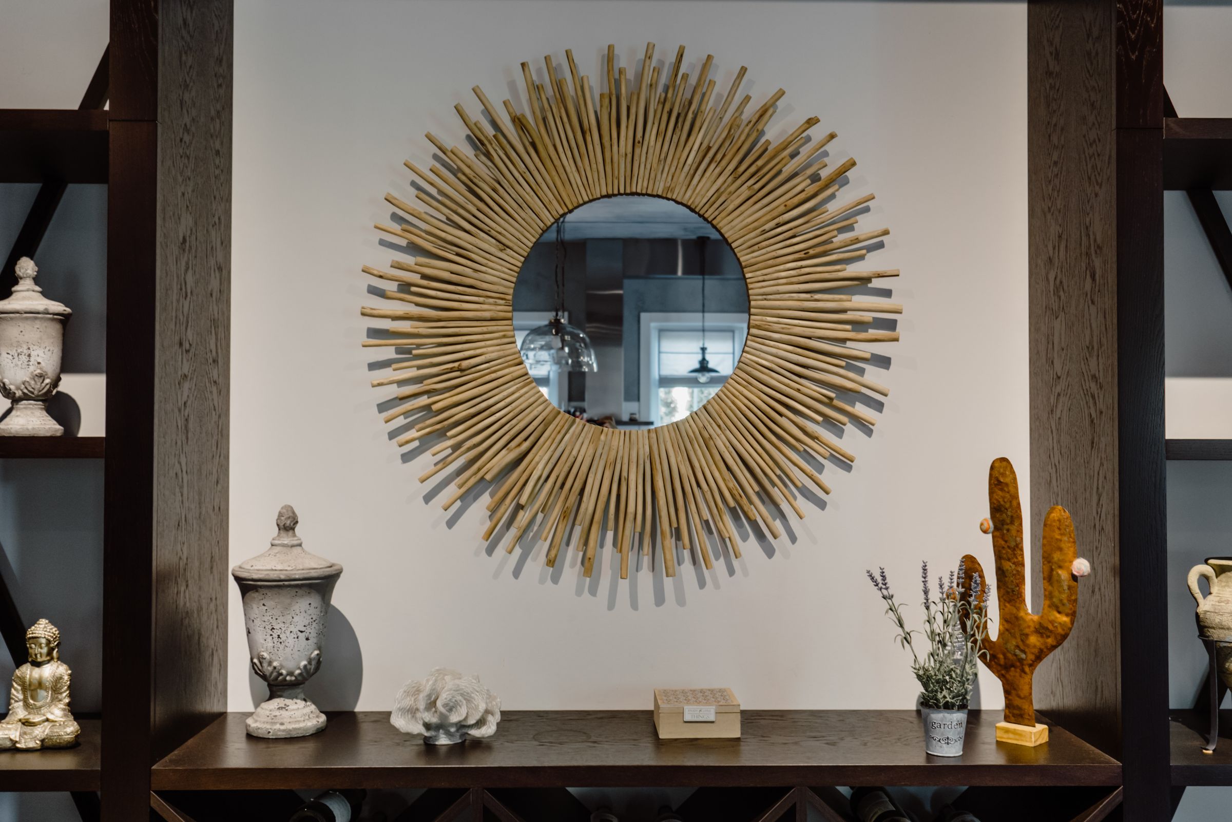 Geometric shaped mirror with brass frame on wall