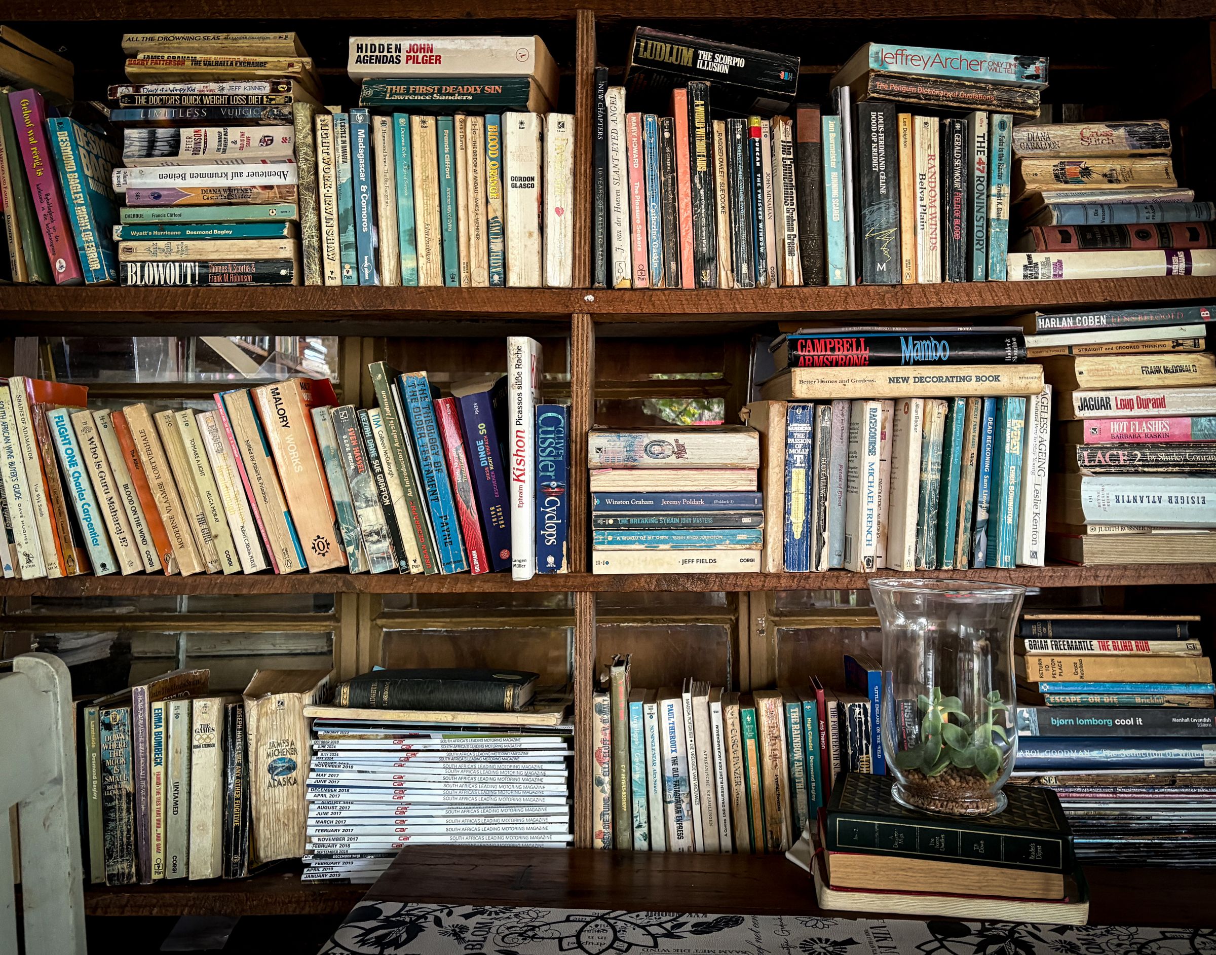 7 Cozy Reading Nook Ideas That Make You Want to Sit Down and Stay 8 Cozy bookshelf filled with vintage books styled with decor