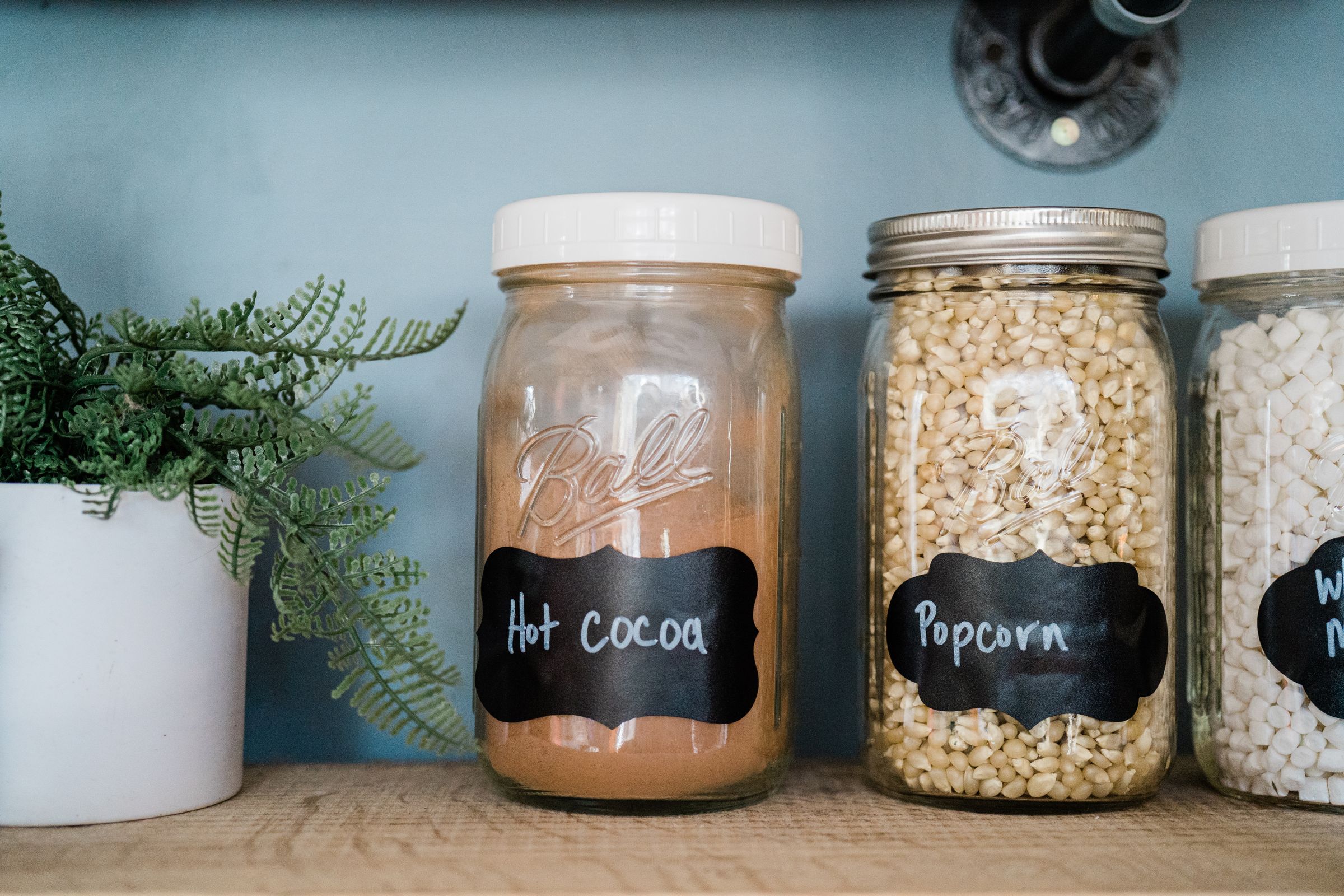 7 Pantry Organization Ideas That Actually Stay Organized 5 Labeled jars organized on a kitchen pantry shelf