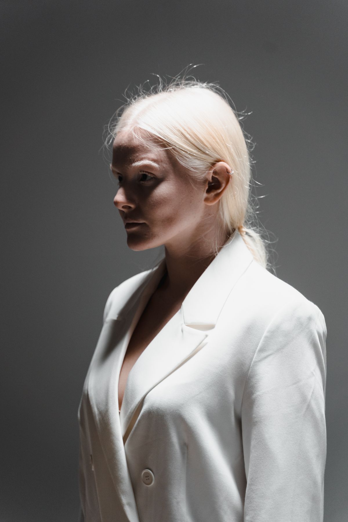 The Allure of Platinum Blonde Hair Color for Women 2 Woman in a white blazer with platinum blonde hair