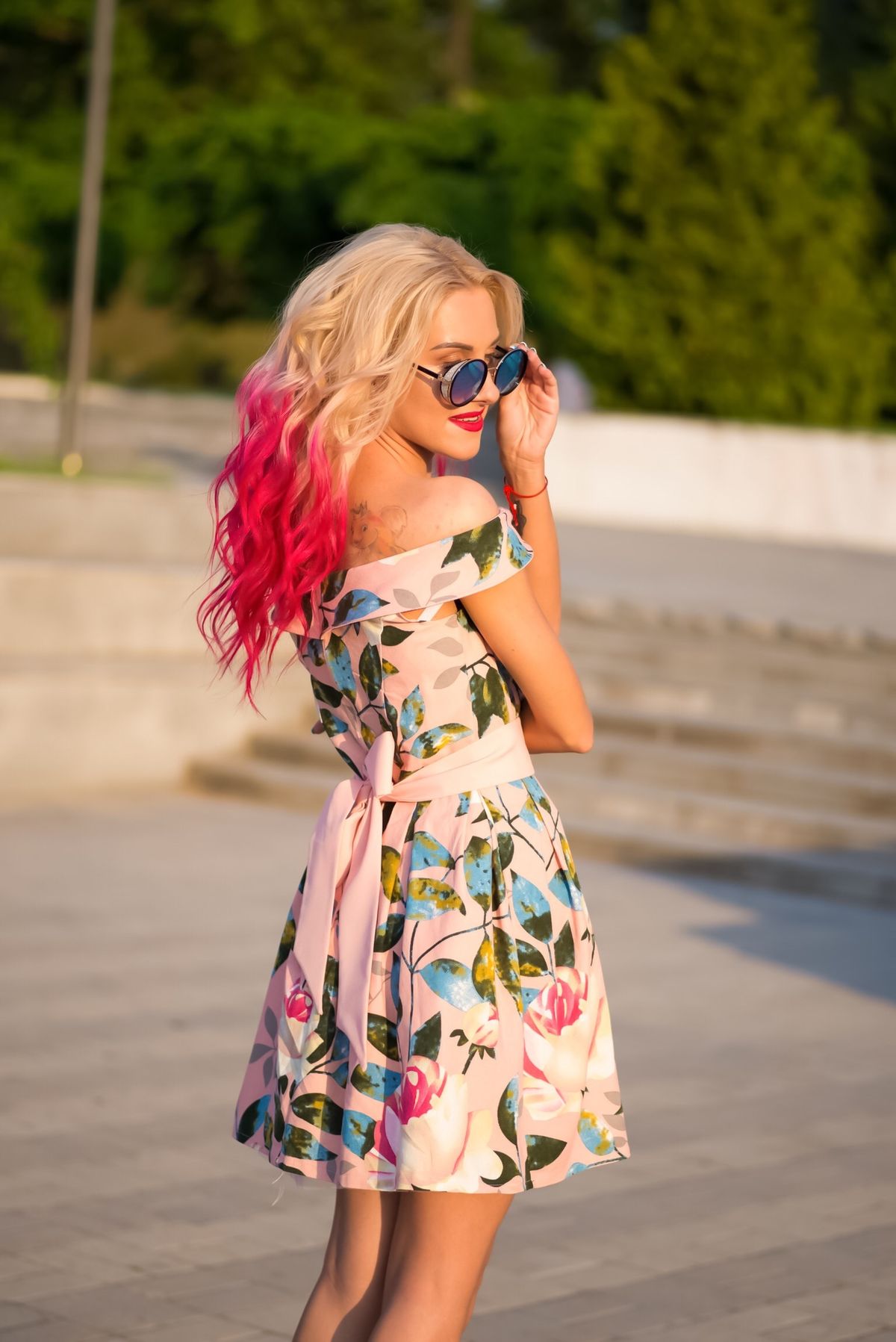 Fashionable woman with rose gold hair outdoors