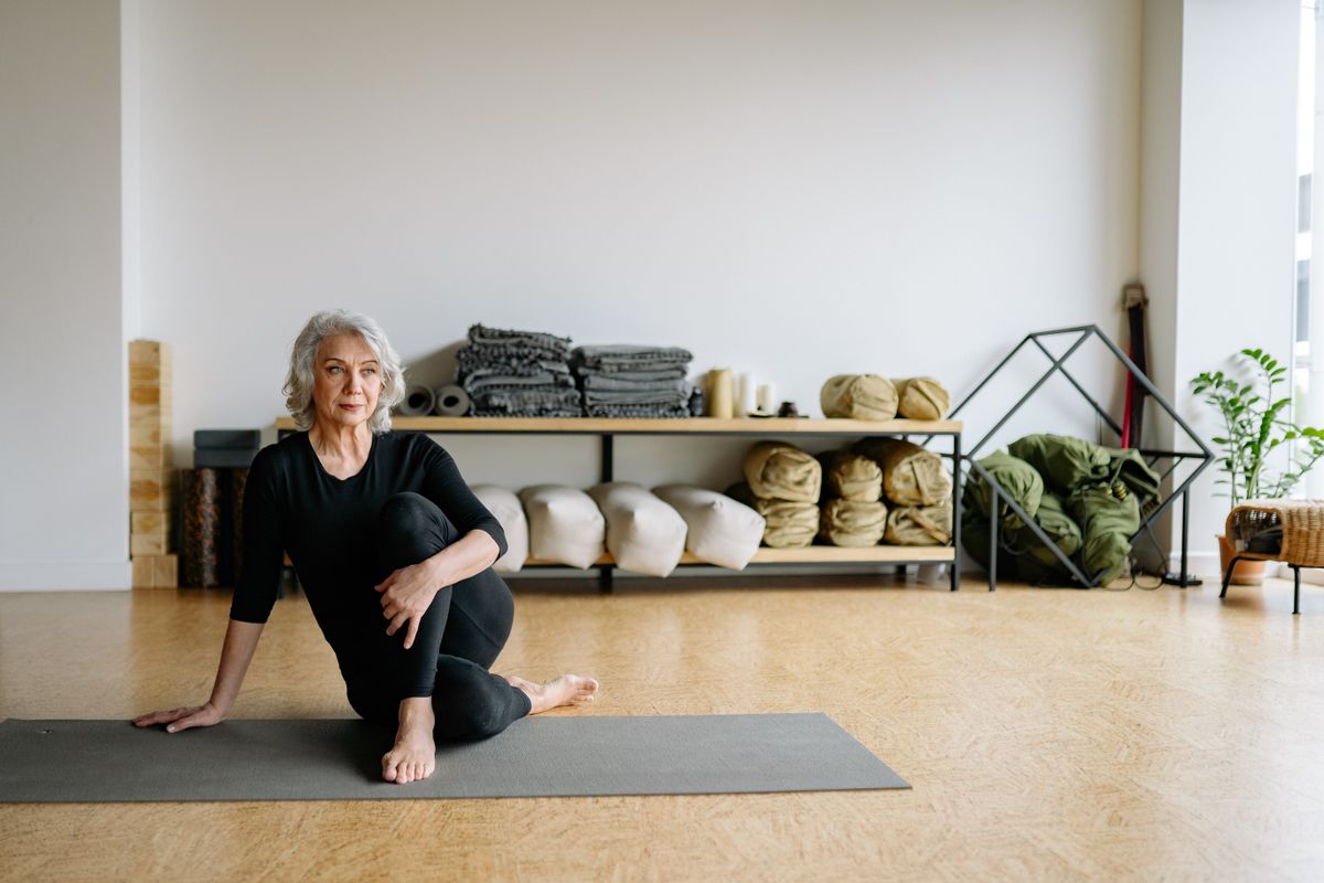 The Beauty, Strength, and Wisdom of Older Women: Embracing Life with Confidence 2 Elderly woman performing yoga in a calm, serene setting