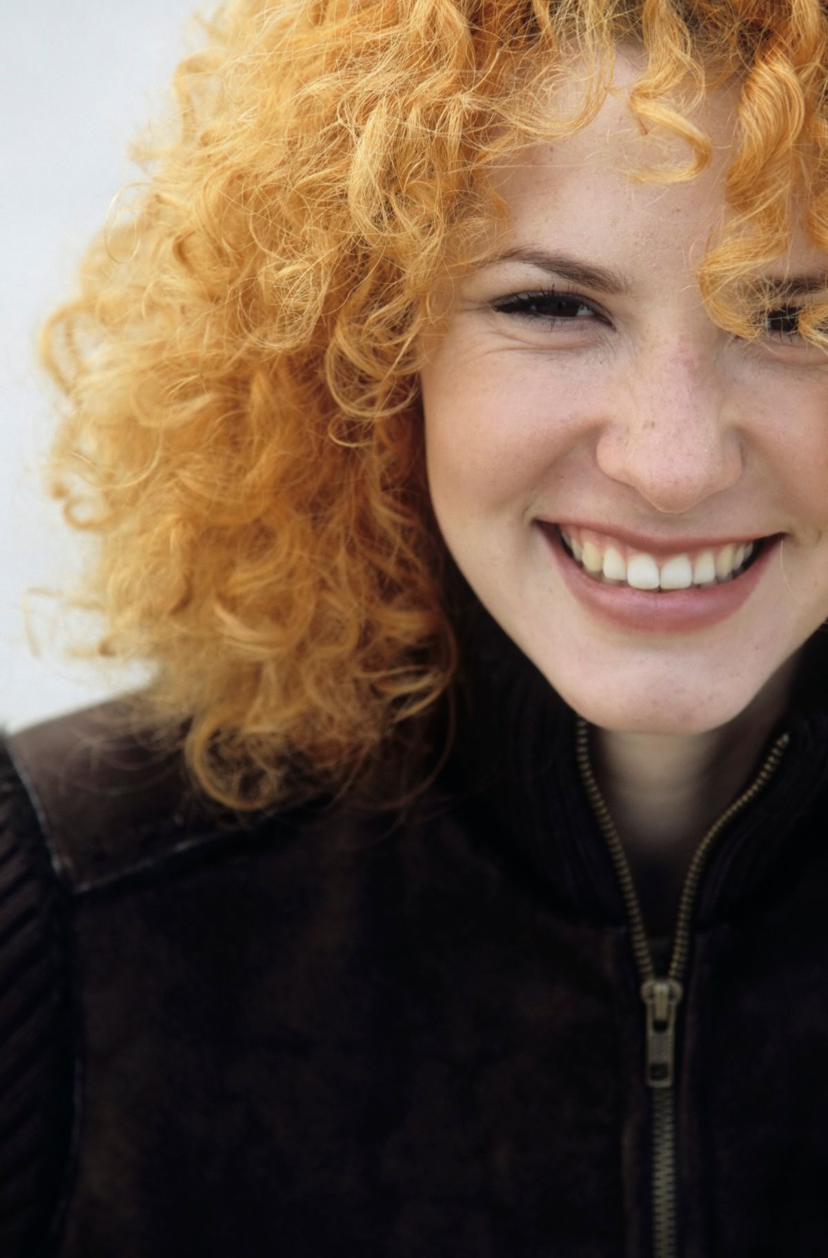 Woman with curly strawberry blonde hair