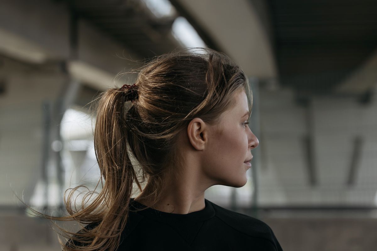 The Wolf Cut: A Bold and Trendy Hairstyle for Women 2 Woman with layered hair styled in a ponytail