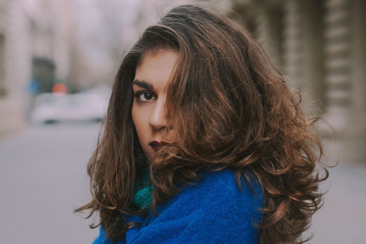Woman with voluminous layered wolf cut hairstyle