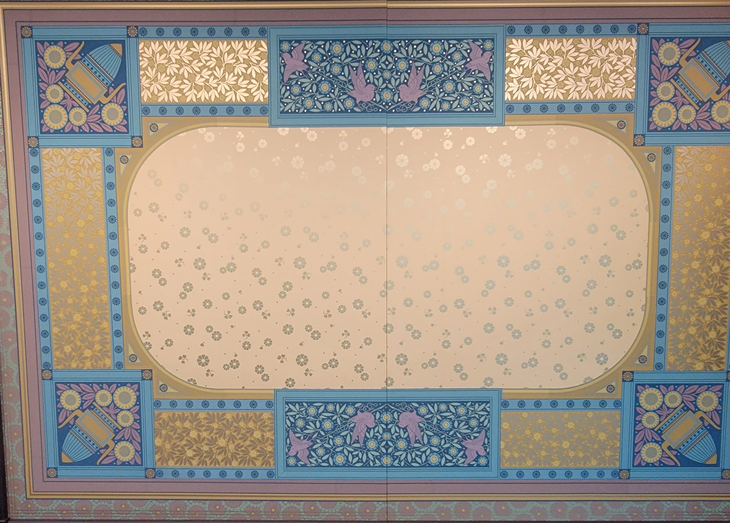 Ornate historic ceiling wallpaper paired with decorative painted trim