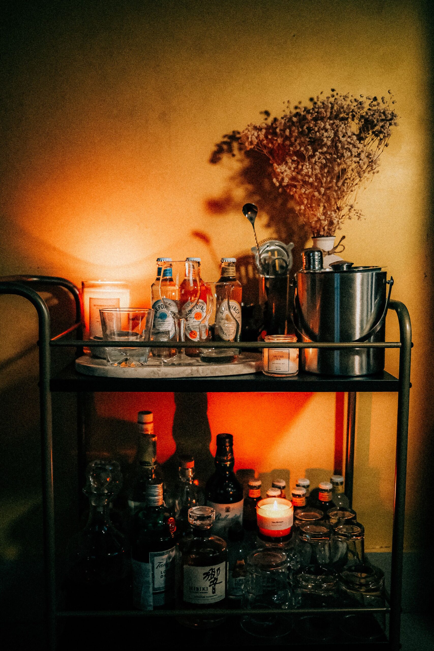 Elegant Halloween Decor Ideas for Every Room in Your Home 5 Elegant styled bar cart with classic cocktails and warm lighting, photo by Miscellaneous Das via Pexels