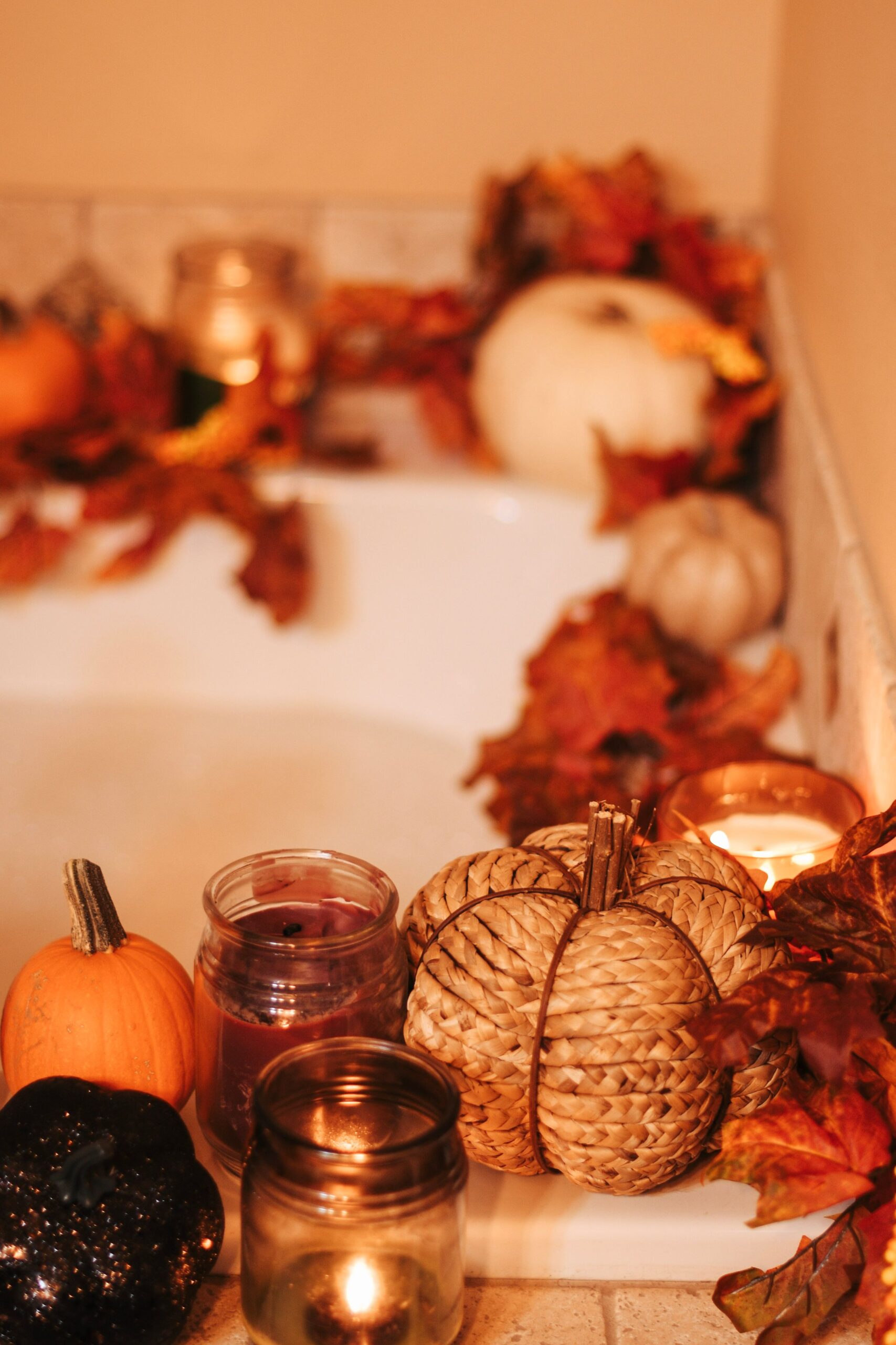 Elegant Halloween Decor Ideas for Every Room in Your Home 8 Bathtub edge styled with candles, dried leaves, and small pumpkins for a spa-like Halloween look, photo by Jenny Uhling via Pexels