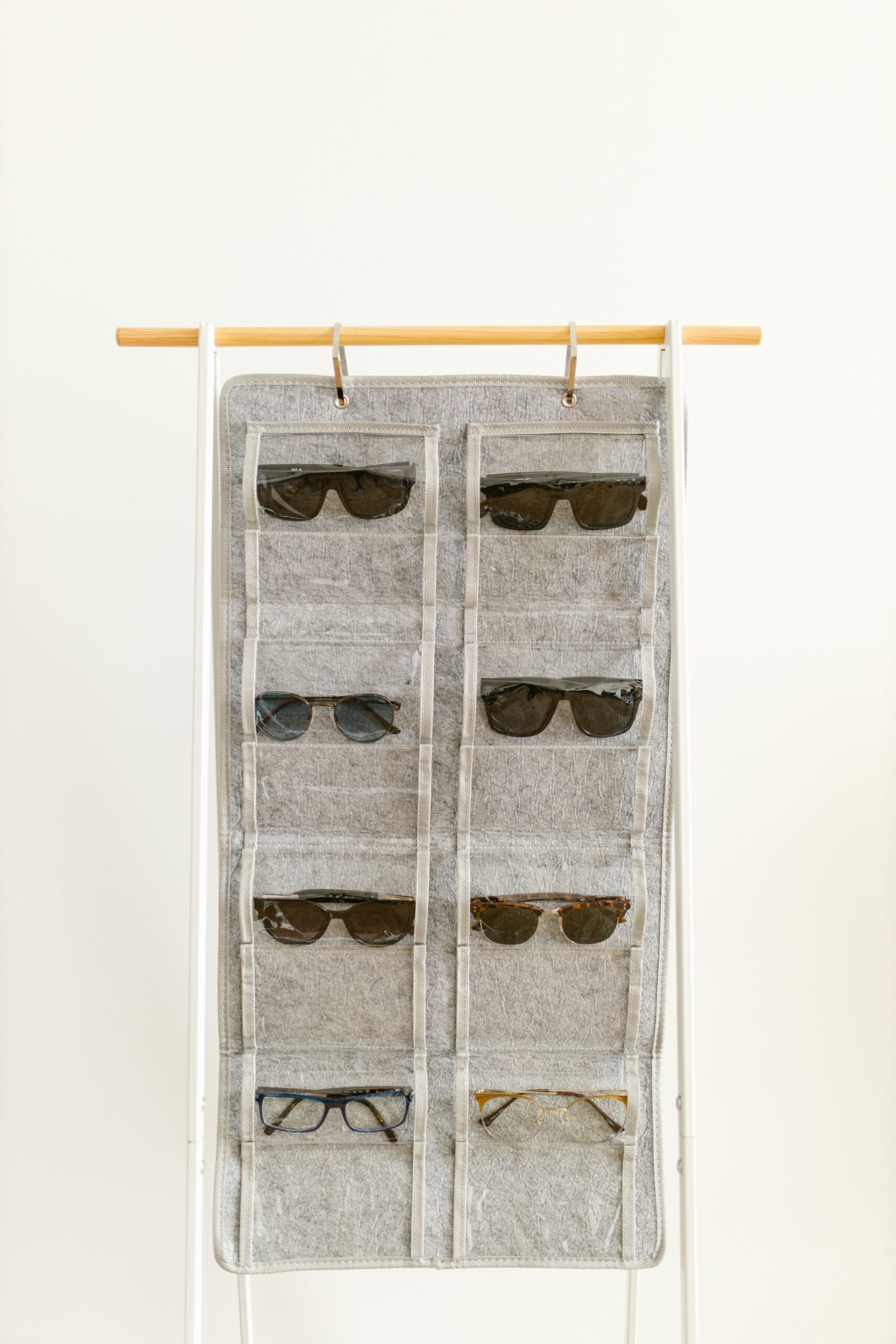 Closet Organization Ideas That Actually Make Getting Dressed Easier 6 Hanging fabric organizer with multiple pockets holding sunglasses, photo by RDNE Stock project via Pexels