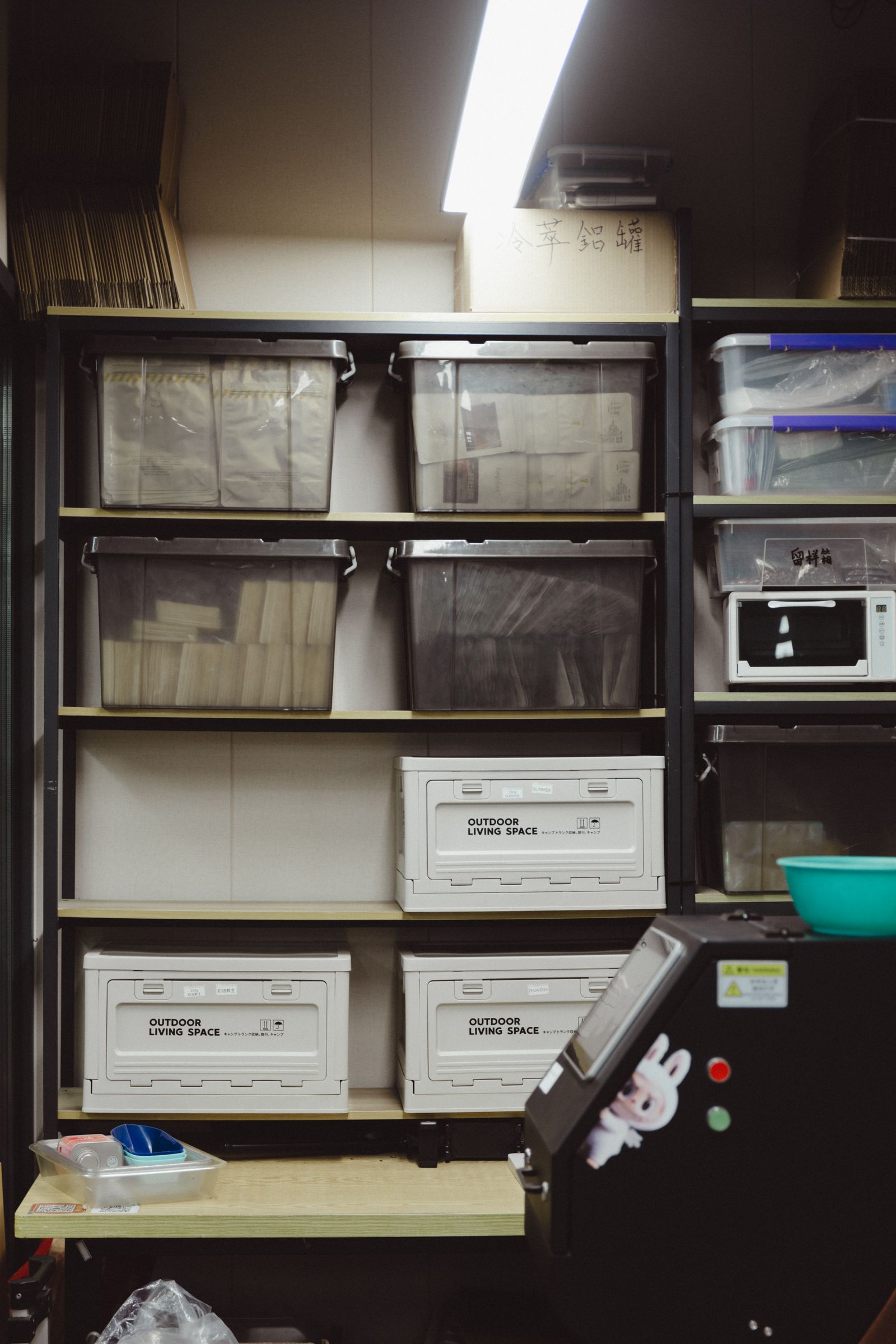 Garage Organization Ideas That Make Room for the Car Again 5 Shelves of clear and labeled plastic storage containers in an organized storage room, photo by Usman AbdulrasheedGambo via Pexels