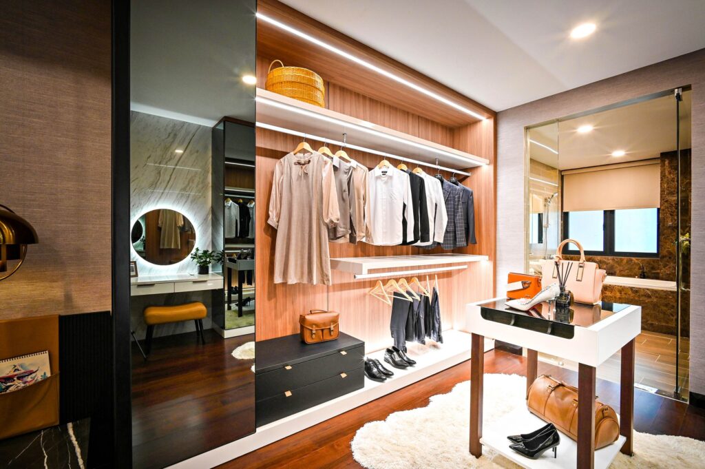 Elegant wide walk-in closet with styled clothing, bags and accessories, photo by Huy Quang Nguyen via Pexels