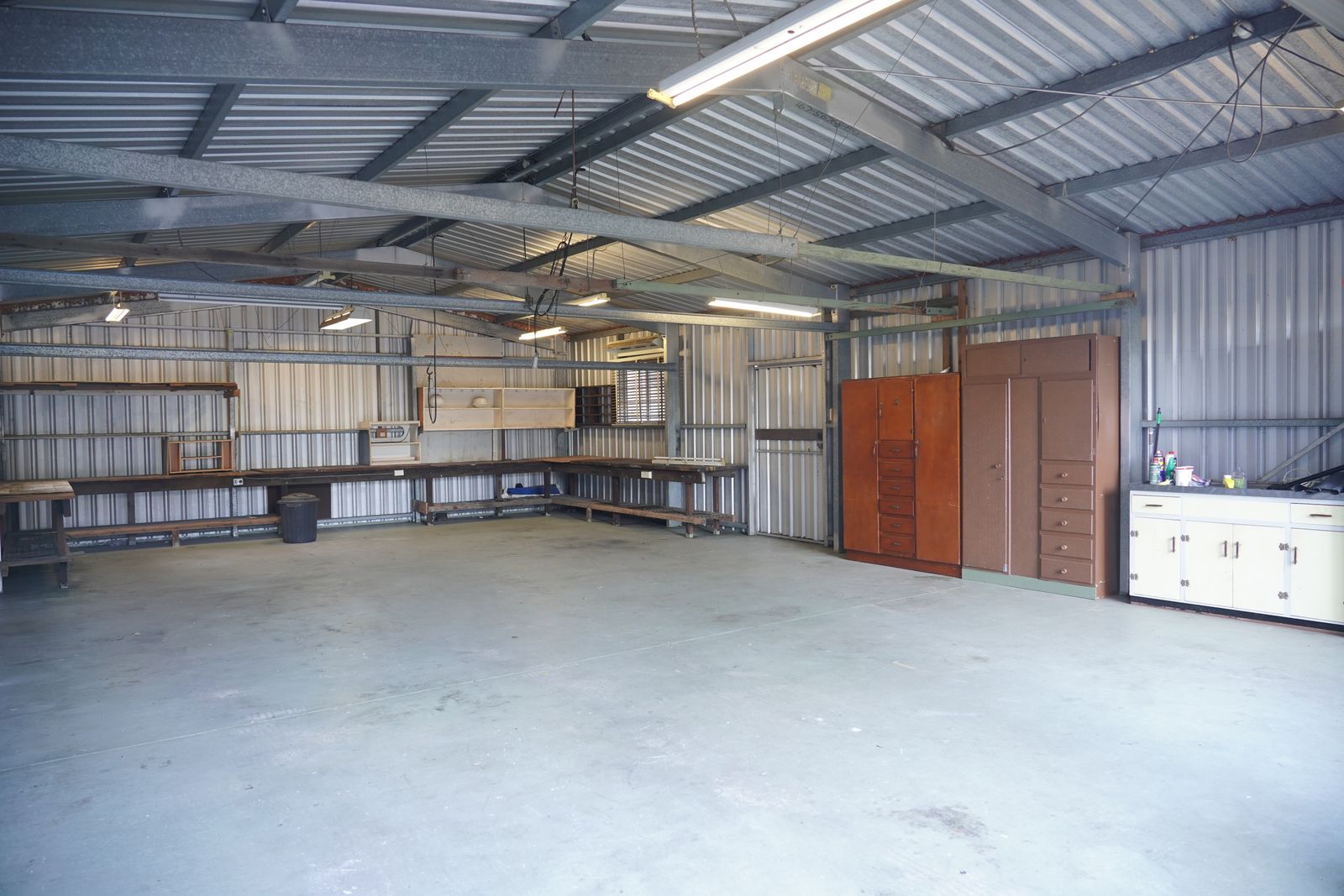 Garage Organization Ideas That Make Room for the Car Again 8 Clean open garage with built in cabinets along the back wall and clear floor space, photo by Kevin Chuang via Pexels