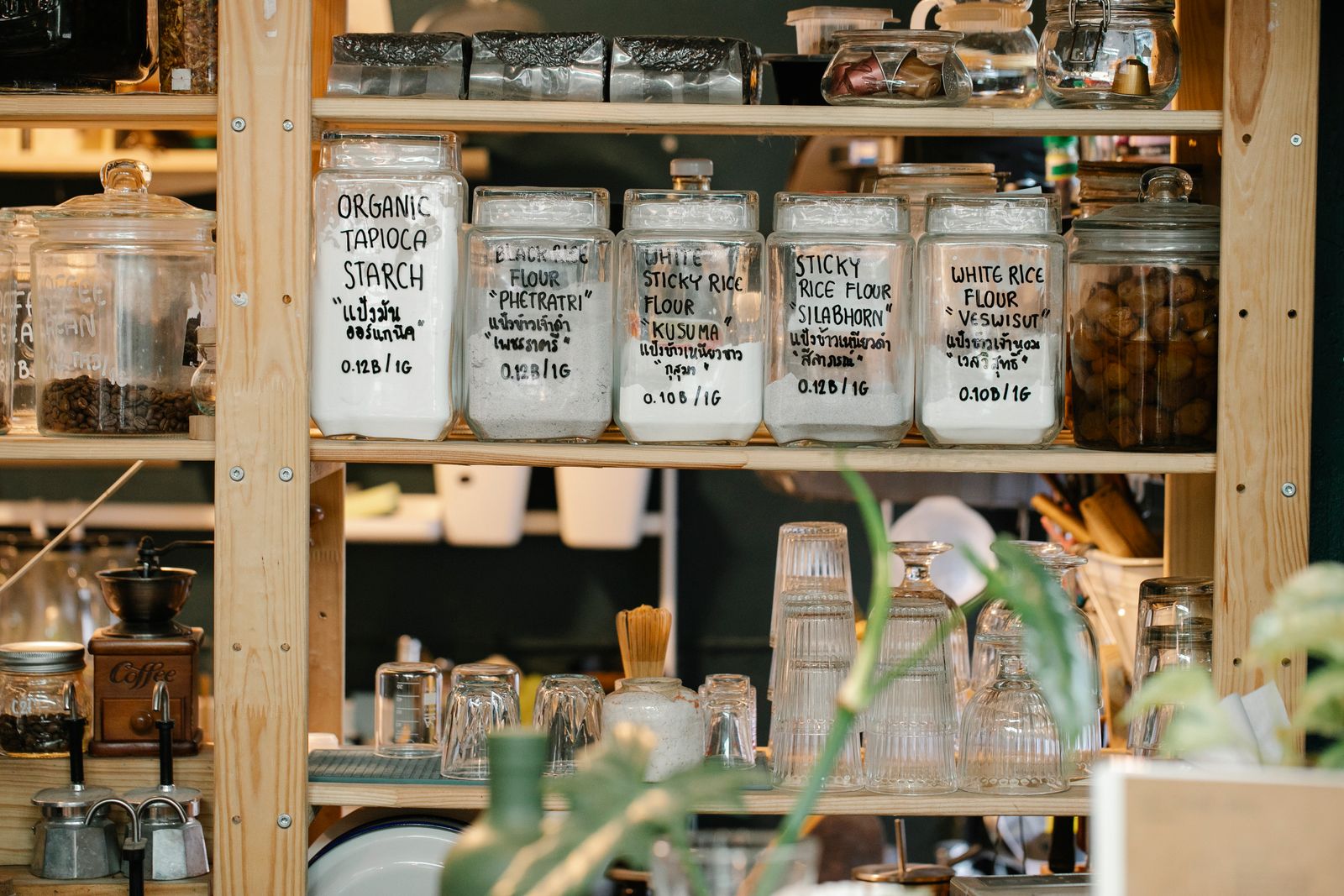 7 Pantry Organization Ideas That Actually Stay Organized 3 Labeled glass jars of dry goods on wooden pantry shelves, photo by Sarah Chai via Pexels