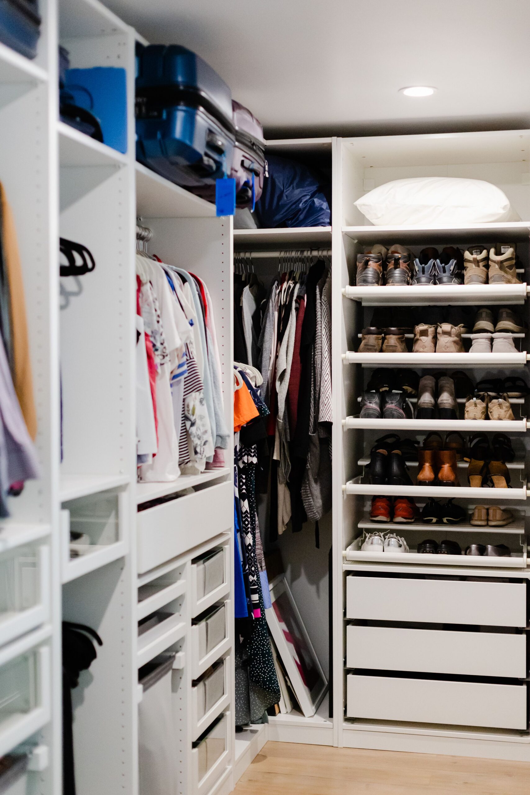 Closet Organization Ideas That Actually Make Getting Dressed Easier 4 Organized closet shoe shelves holding sneakers and boots in rows, photo by ASR Design Studio via Pexels